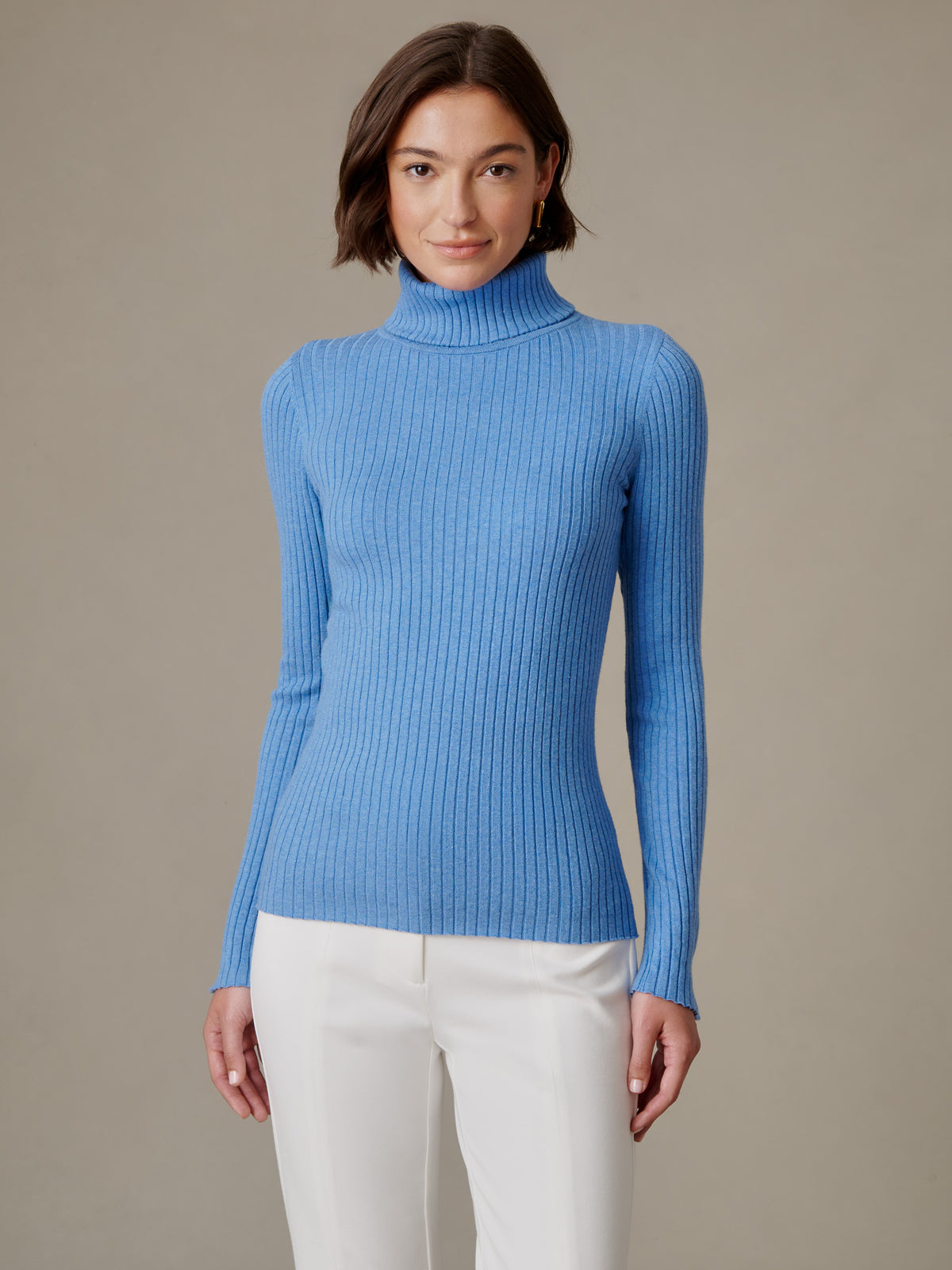 J.McLaughlin Arlette Turtleneck blue ribbed long sleeve top worn with white pants