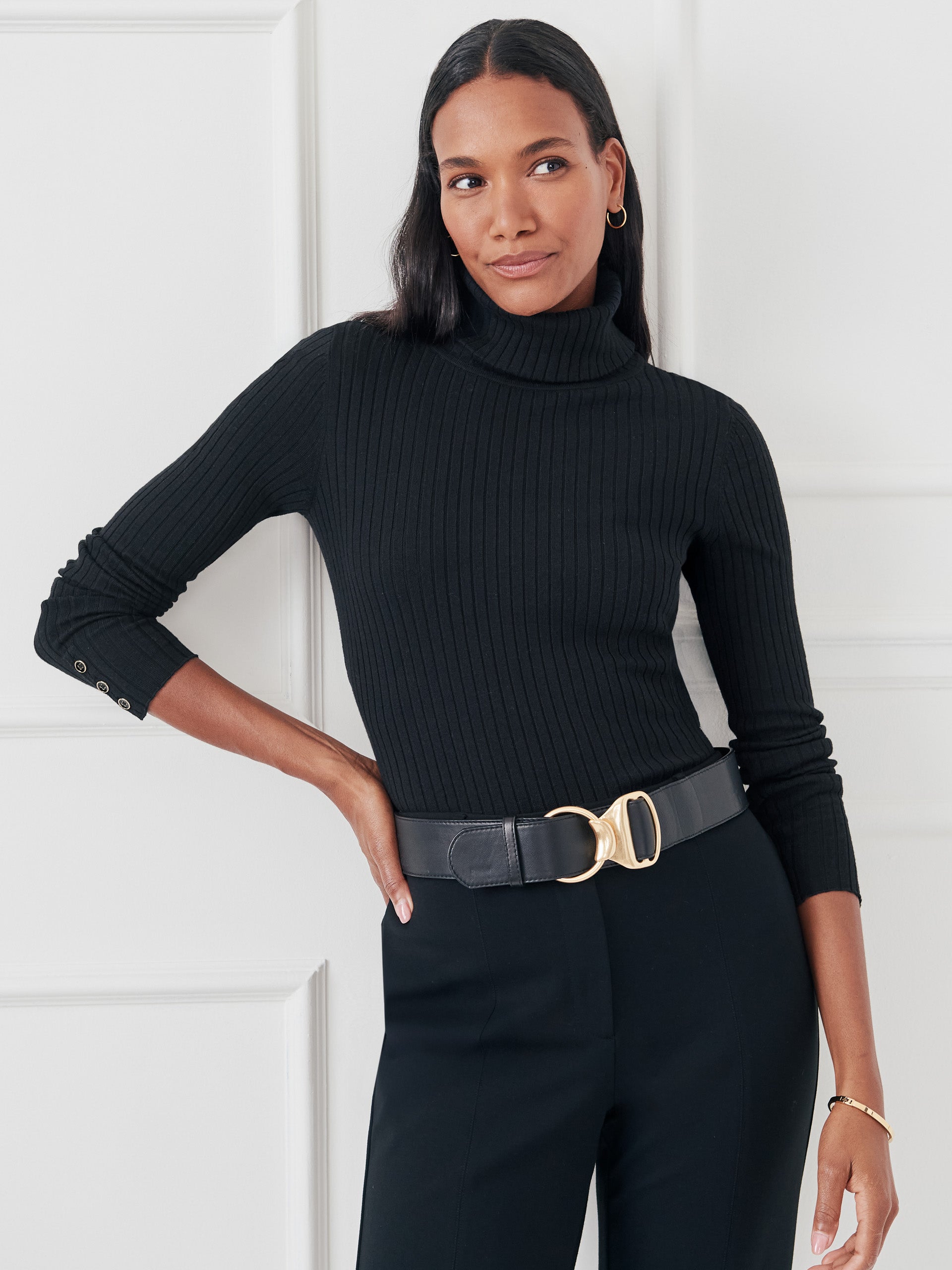 Model wearing J.McLaughlin Arlette turtleneck in black made with cotton/modal.