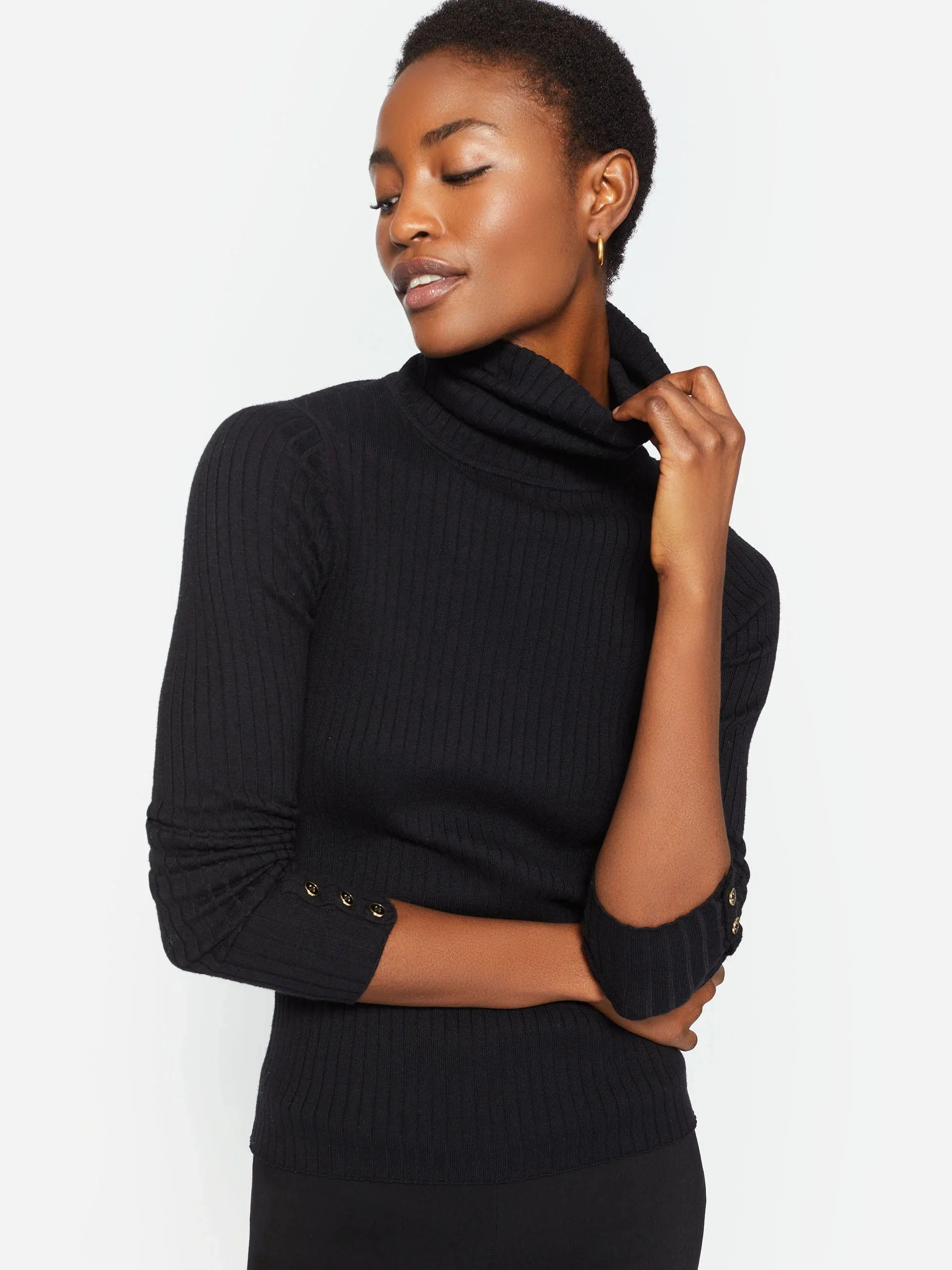 Model wearing J.McLaughlin Arlette turtleneck in black made with cotton/modal.