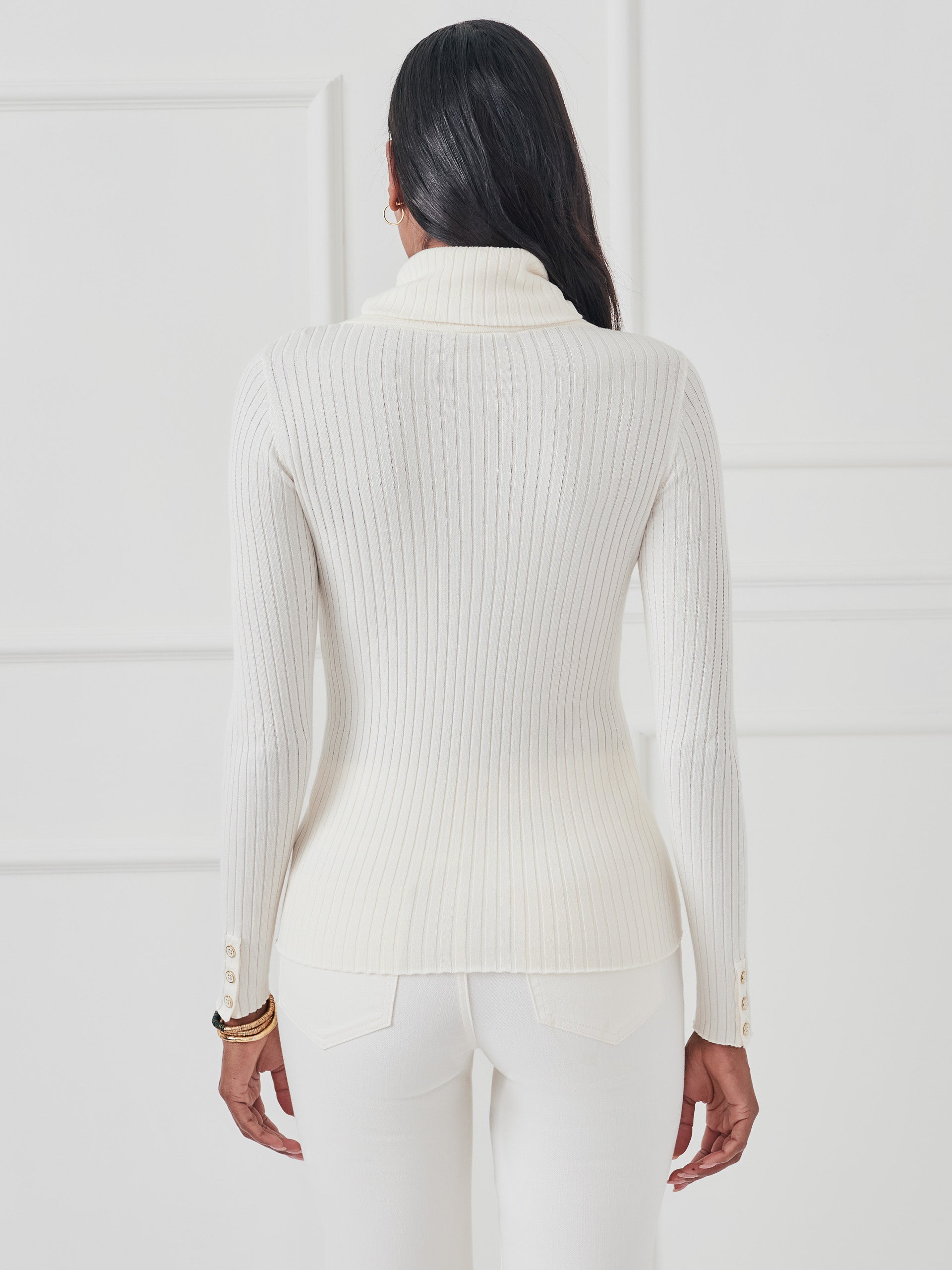 Model wearing J.McLaughlin Arlette turtleneck in egret white made with cotton/modal.