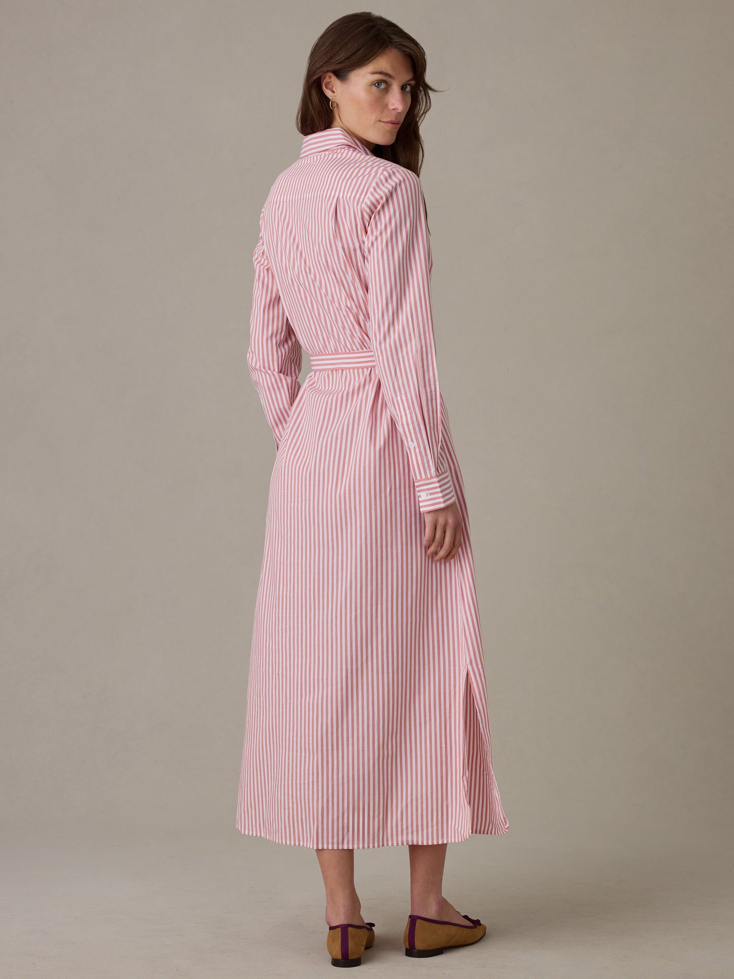 Woman seen from behind wearing a Leighton Dress in Stripe by J.McLaughlin, featuring vertical red and white stripes, a belted waist, collared neckline, and long sleeves for an effortlessly stylish look.