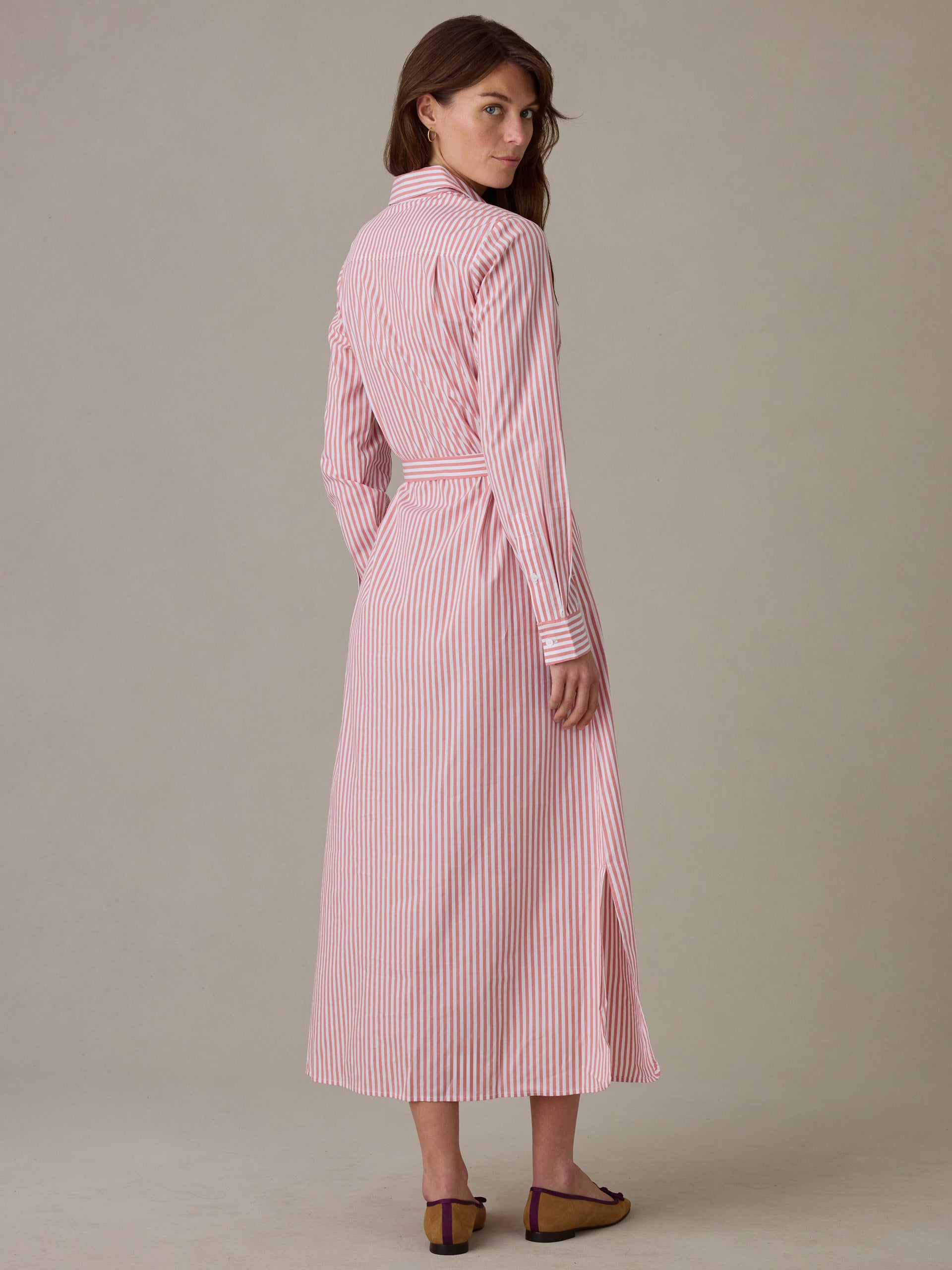 Woman seen from behind wearing a Leighton Dress in Stripe by J.McLaughlin, featuring vertical red and white stripes, a belted waist, collared neckline, and long sleeves for an effortlessly stylish look.
