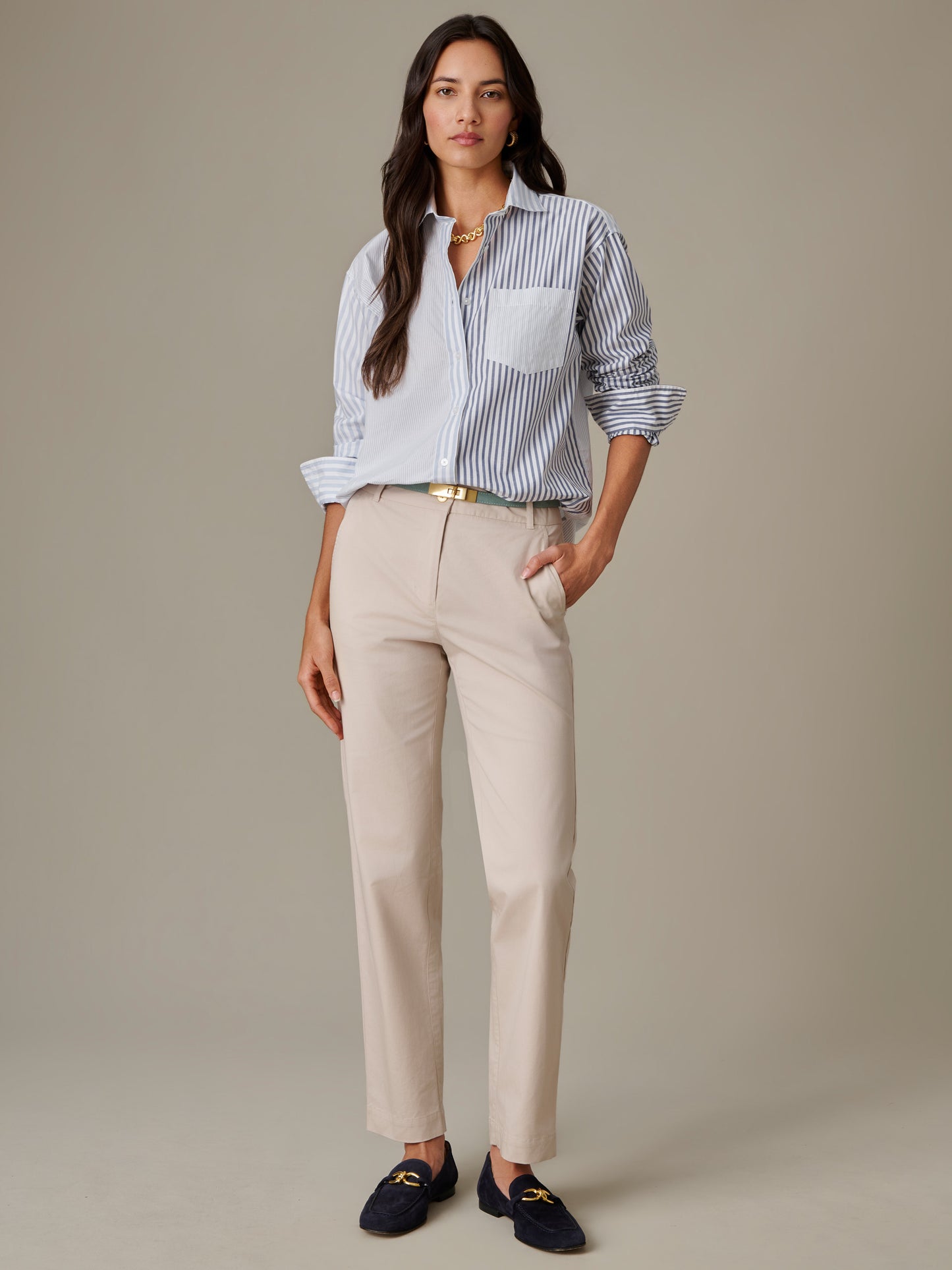 Woman wearing Avery Cotton Chino Pants by J.McLaughlin paired with a striped button-up shirt and navy loafers, showcasing effortlessly stylish, enduring designs.