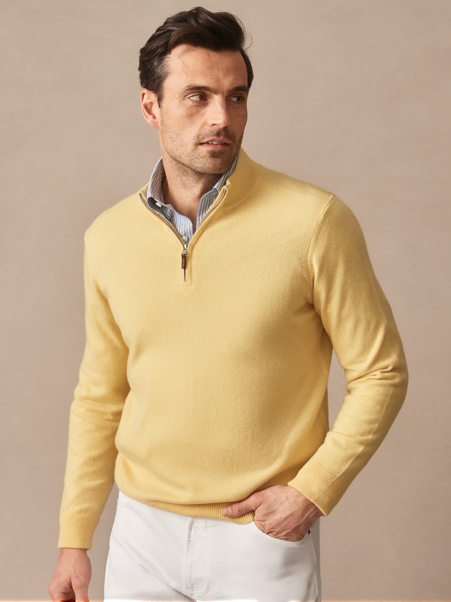 Man wearing a yellow Twain Cashmere 1/4 Zip sweater by J.McLaughlin, showcasing effortlessly stylish, enduring designs crafted from innovative fabrics, perfect for a life well-lived.