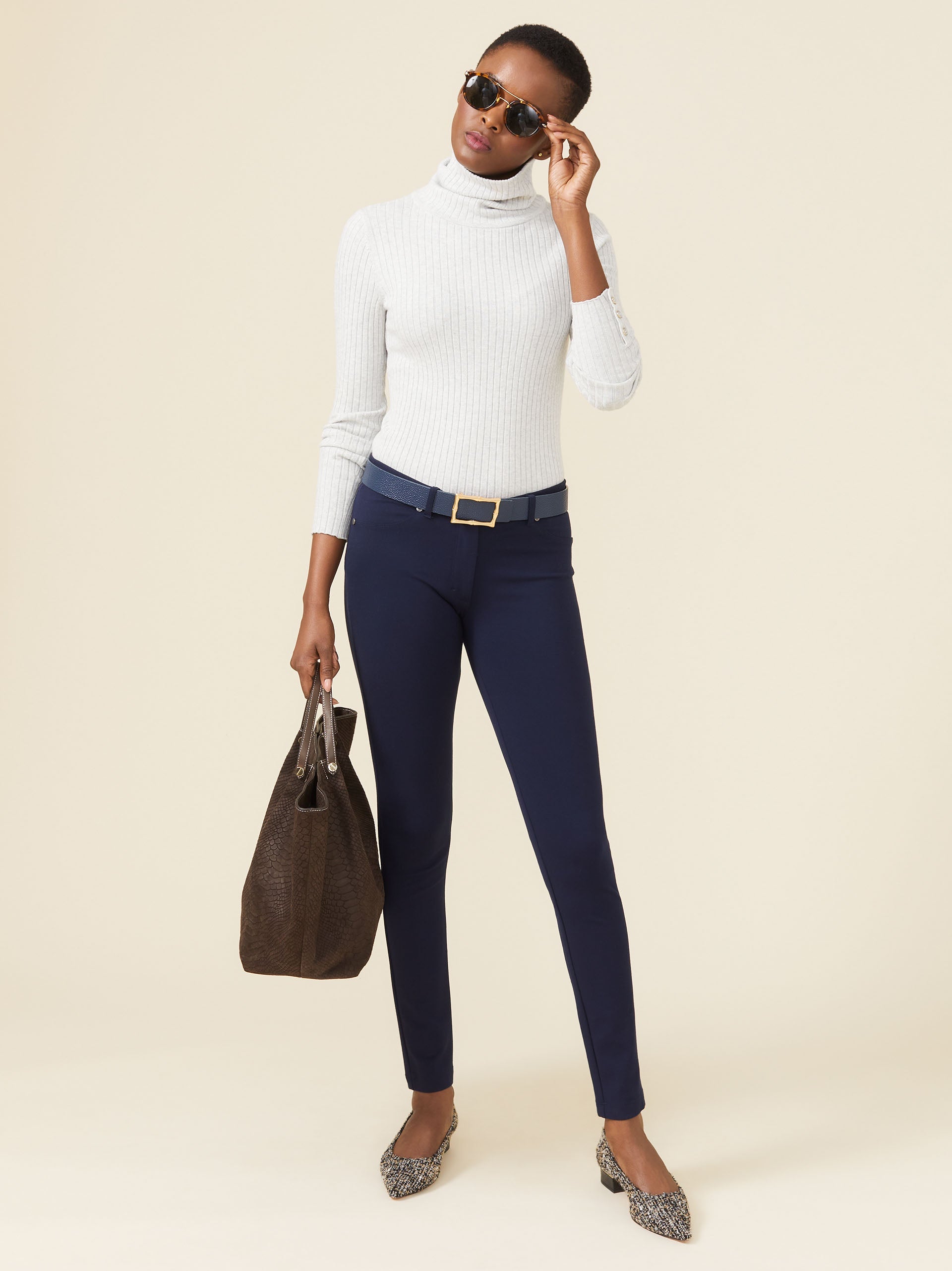 Model wearing J.McLaughlin Becca leggings in winter navy made with Bainbridge fabric.