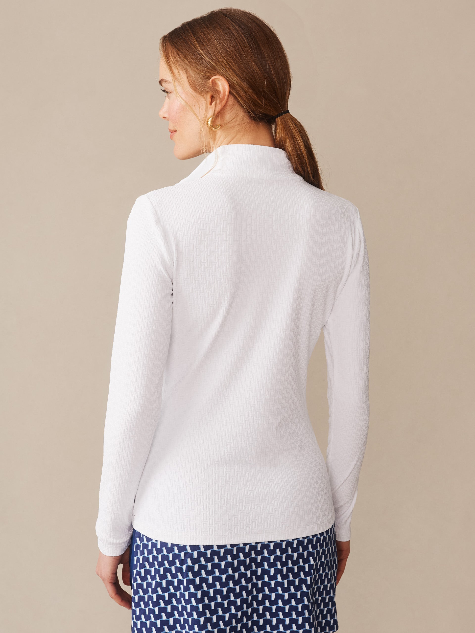 Woman wearing the Bedford Top in Dashing Jacquard by J.McLaughlin, featuring effortlessly stylish, enduring designs with innovative fabrics in a timeless white textured top, a destination for defining style. Life, Well-Lived.