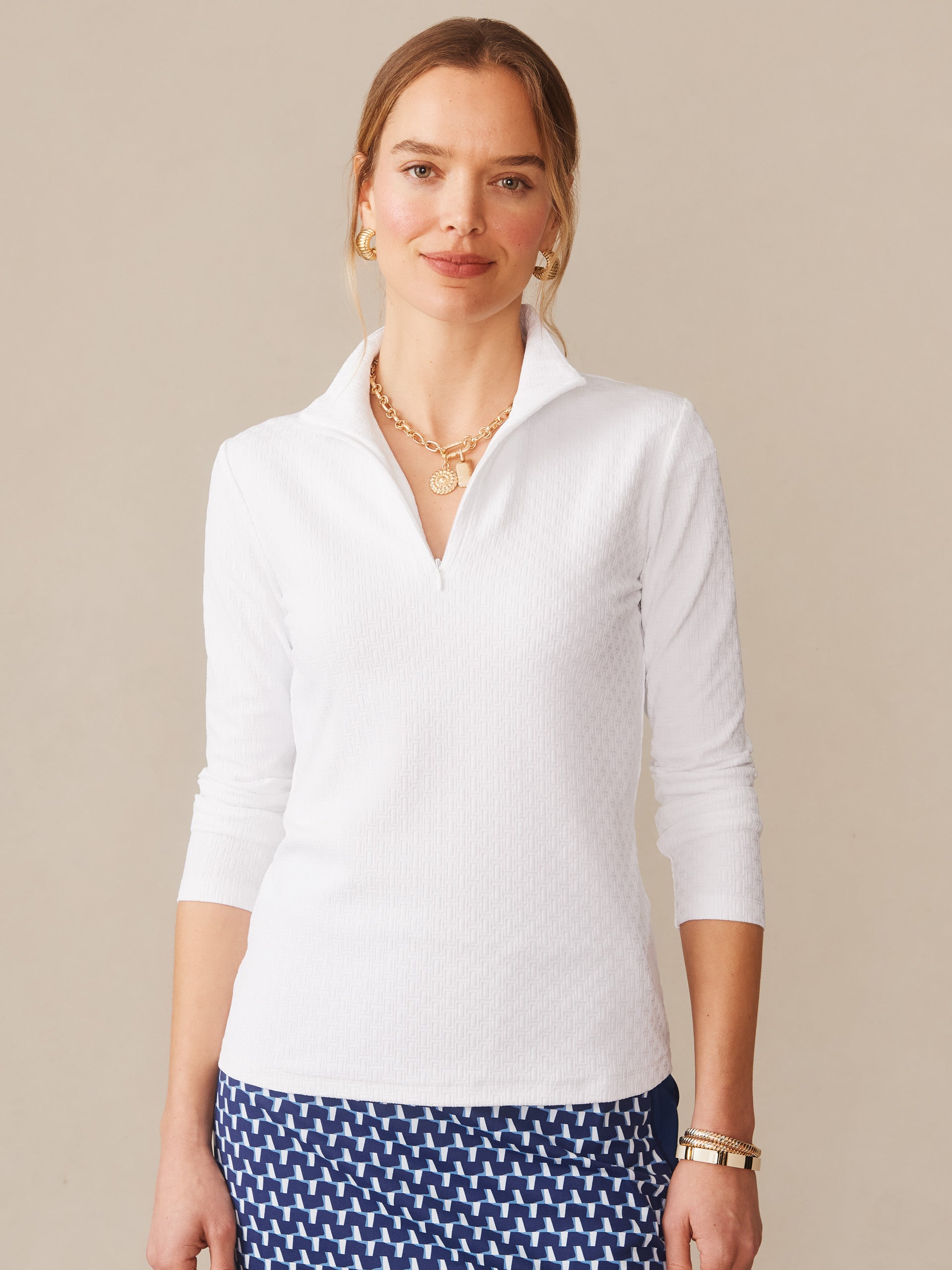 A woman wearing the Bedford Top in Dashing Jacquard by J.McLaughlin, showcasing effortlessly stylish and enduring designs with innovative fabrics, embodying a legacy of timeless fashion. A destination for defining style. Life, Well-Lived.