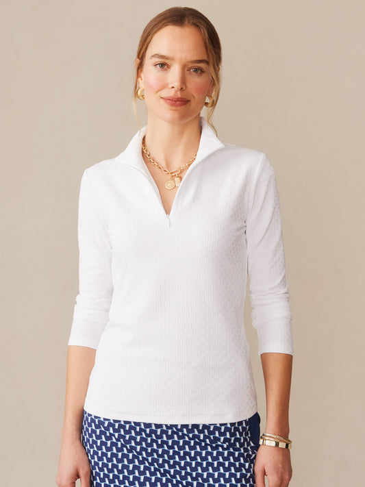 A woman wearing the Bedford Top in Dashing Jacquard by J.McLaughlin, showcasing effortlessly stylish and enduring designs with innovative fabrics, embodying a legacy of timeless fashion. A destination for defining style. Life, Well-Lived.