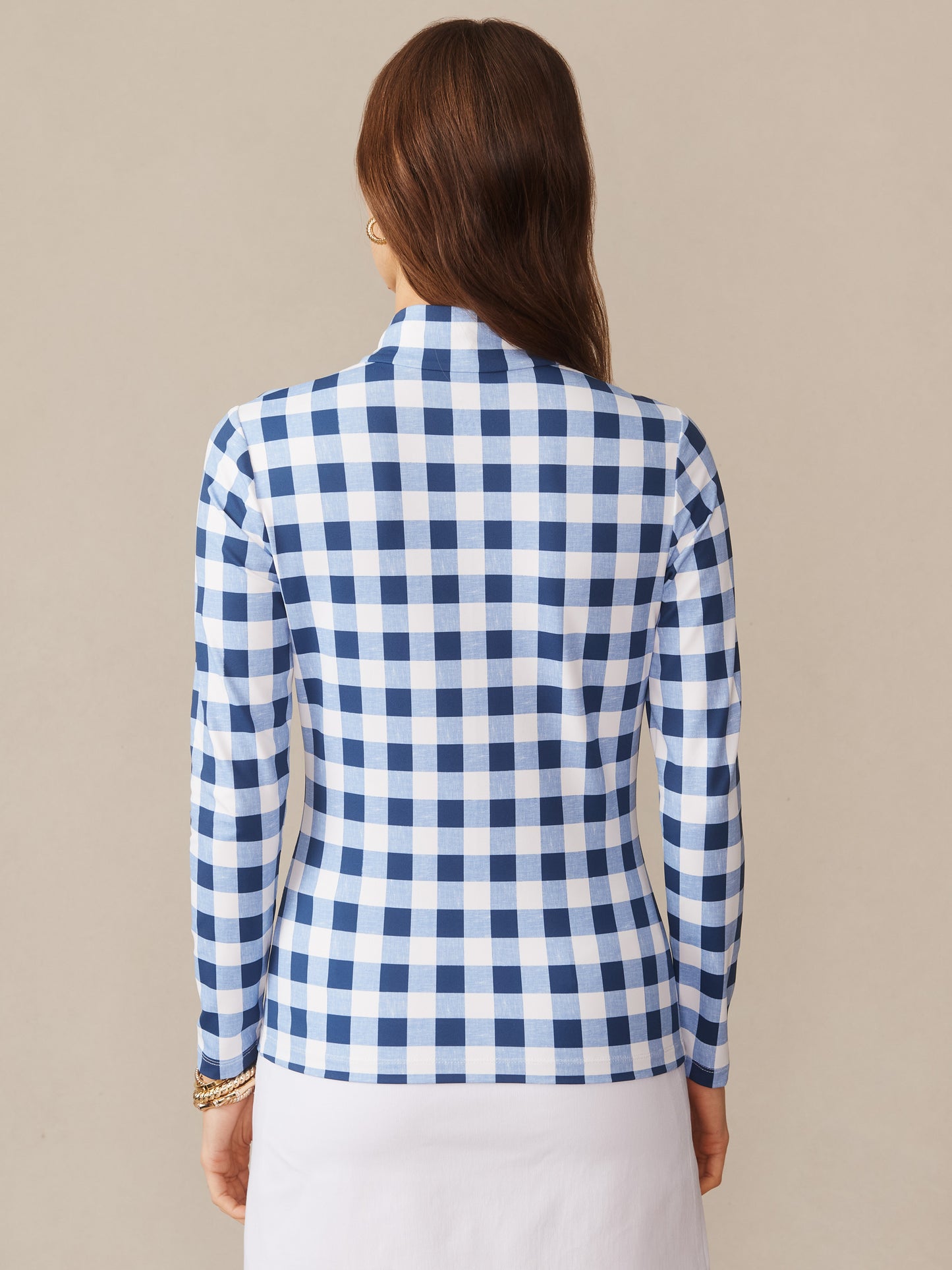 Back view of a woman wearing the Bedford Top in Textured Gingham by J.McLaughlin, featuring a classic blue and white check pattern, effortlessly stylish and embodying enduring designs.