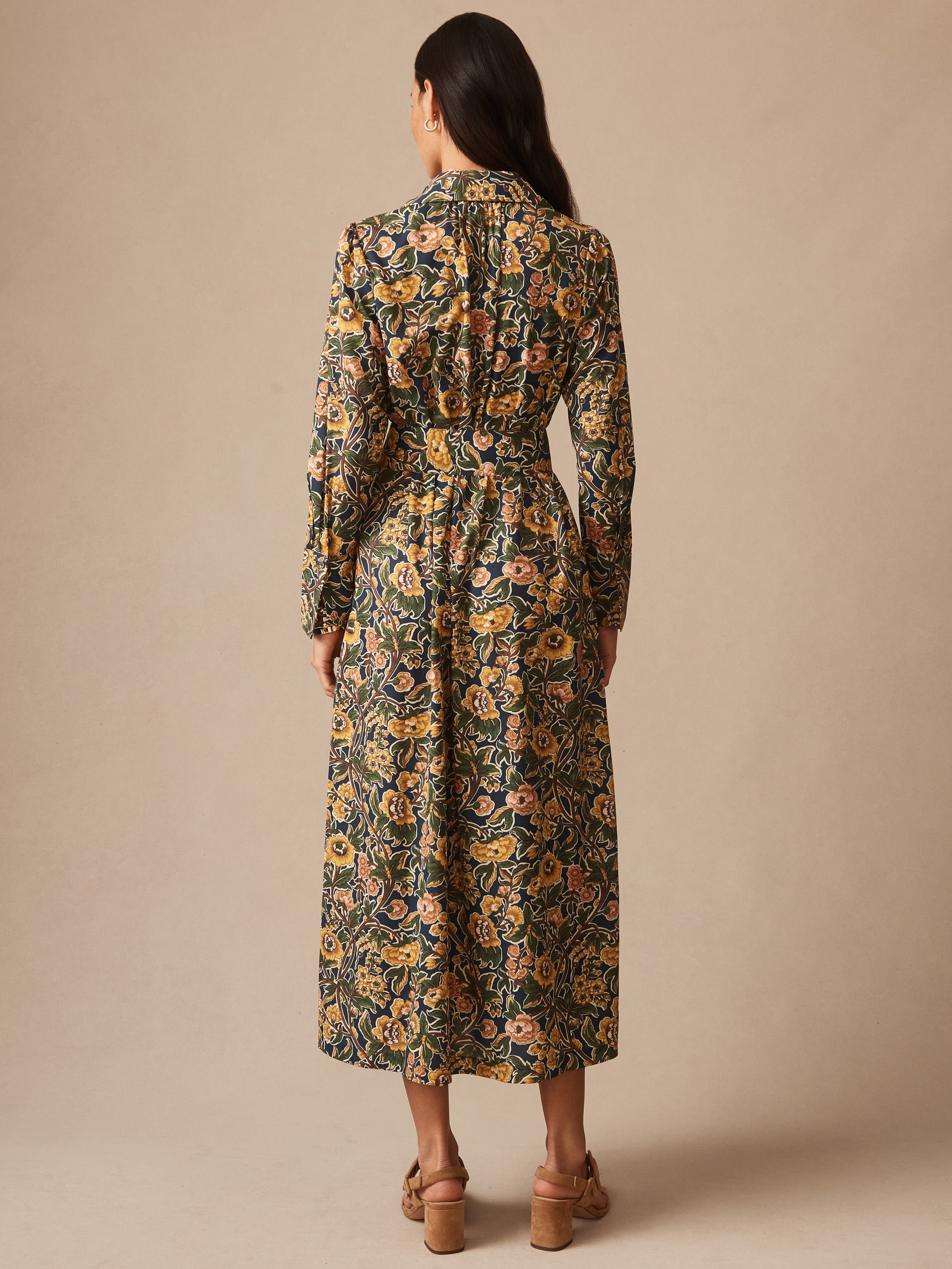 Woman wearing the Belle Dress in Bucolic Blooms by J.McLaughlin, showcasing an effortlessly stylish floral print dress with enduring designs and innovative fabrics in a classic, timeless silhouette.