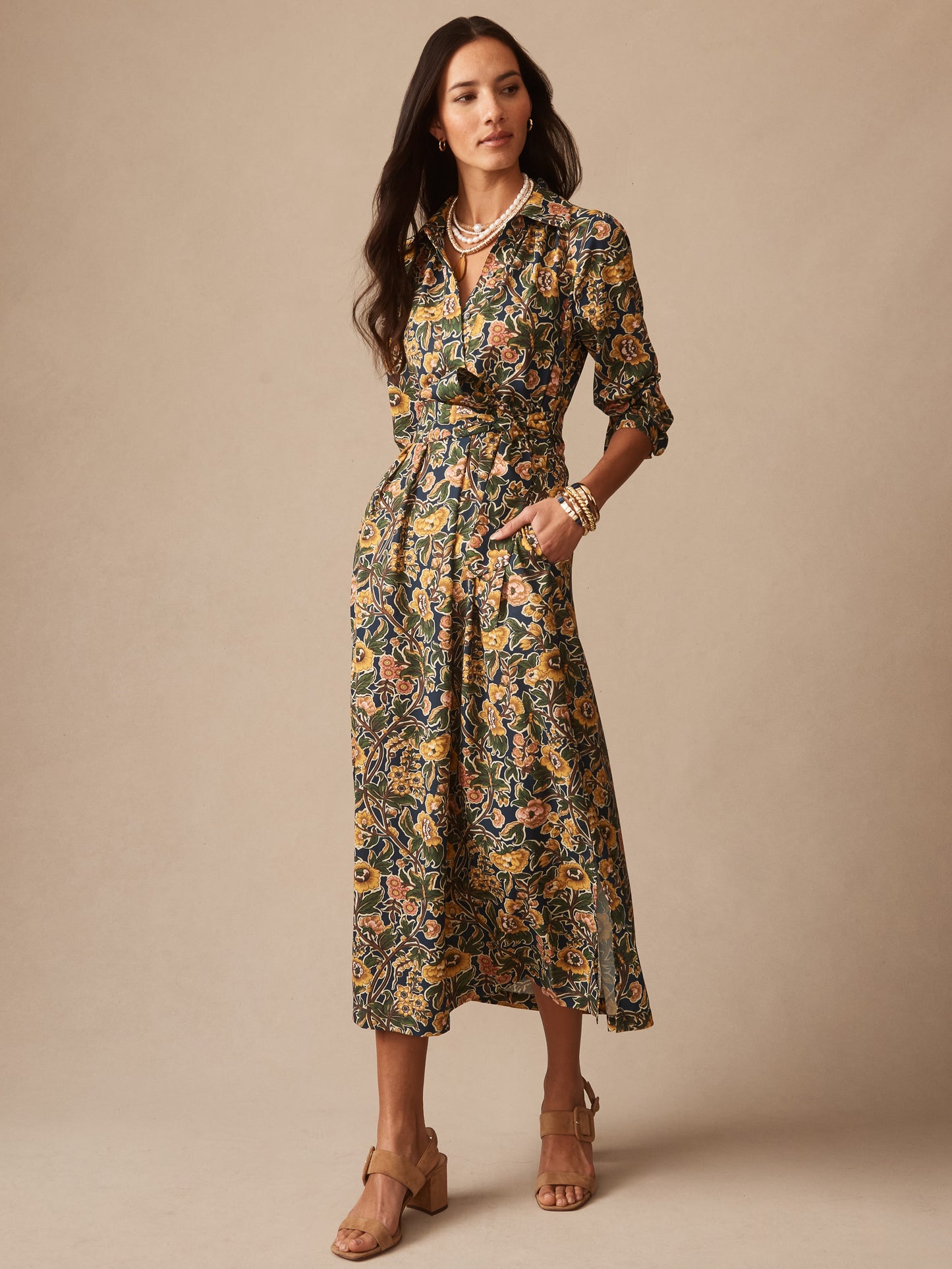 Woman wearing "Belle Dress in Bucolic Blooms" by J.McLaughlin, an effortlessly stylish floral dress with enduring designs and innovative fabric, embodying a legacy of timeless fashion. A destination for defining style. Life, Well-Lived.