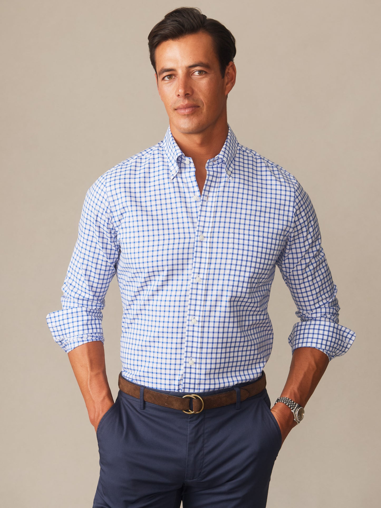 A man wearing a Belvedere Cotton Shirt in Check by J.McLaughlin in a classic blue and white pattern, showcasing effortlessly stylish, enduring designs and innovative fabrics.