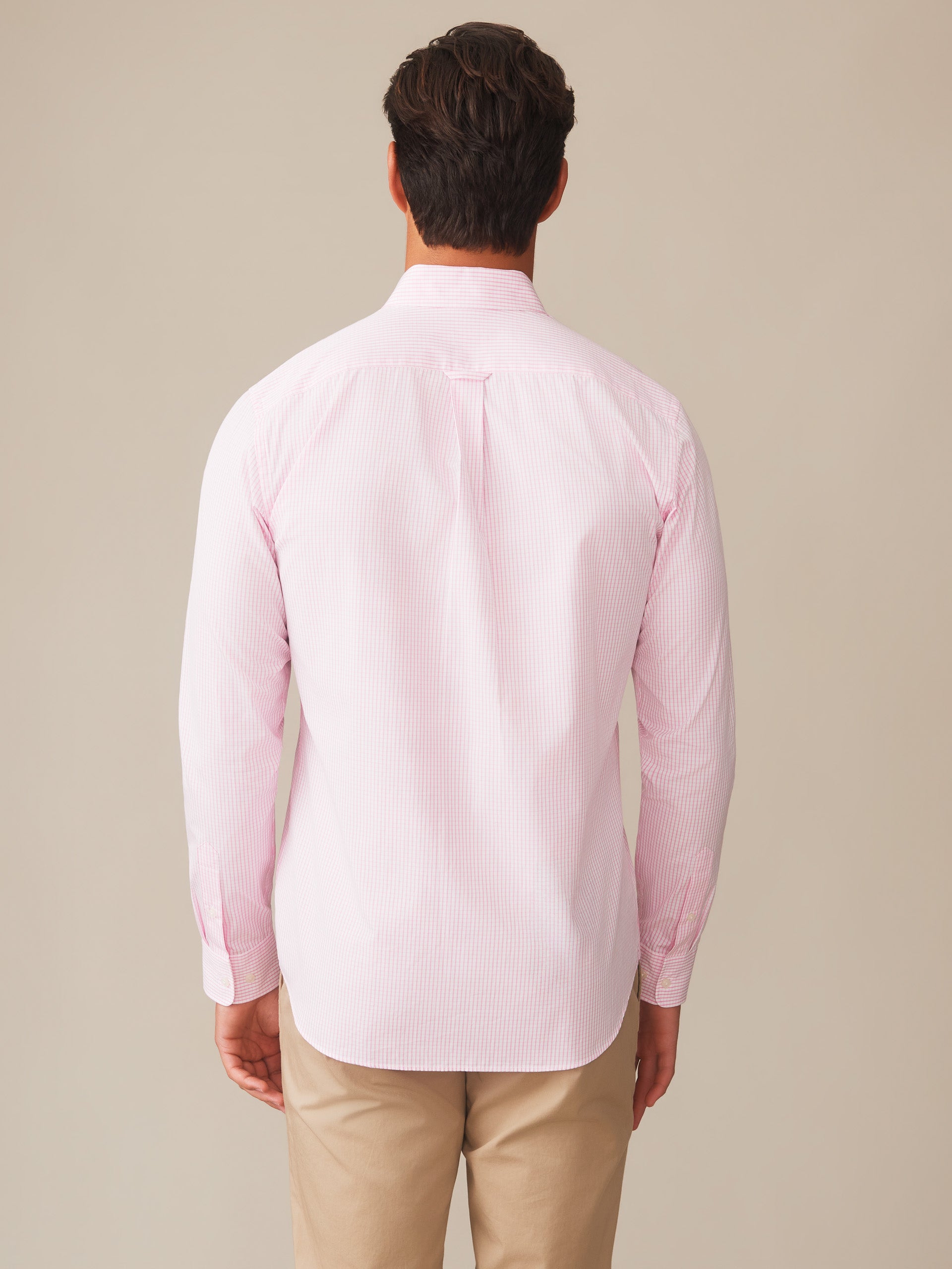 Man wearing a pink Belvedere Cotton Shirt in Graphic Check by J.McLaughlin shown from the back, showcasing effortlessly stylish, enduring designs with innovative fabrics for a legacy of timeless fashion. A destination for defining style. Life, Well-Lived.