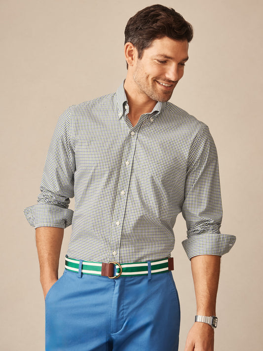 Man wearing a Belvedere Cotton Shirt in Gingham Multi by J.McLaughlin, paired with blue pants and a striped belt, showcasing effortlessly stylish, enduring designs and innovative fabrics.