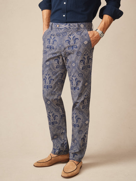 Man wearing Madison Fancy Pants in Baroque Hall with a classic navy shirt and tan loafers, showcasing J. McLaughlin’s effortlessly stylish and enduring designs, a destination for defining style. Life, Well-Lived.