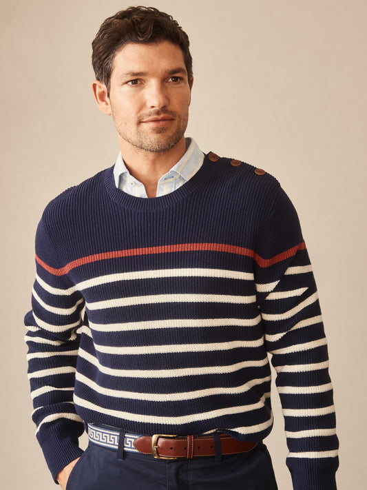 Man wearing a Bennett Sweater in Stripe by J.McLaughlin, featuring navy and off-white stripes with a red accent, embodying effortlessly stylish, enduring designs and innovative fabrics.