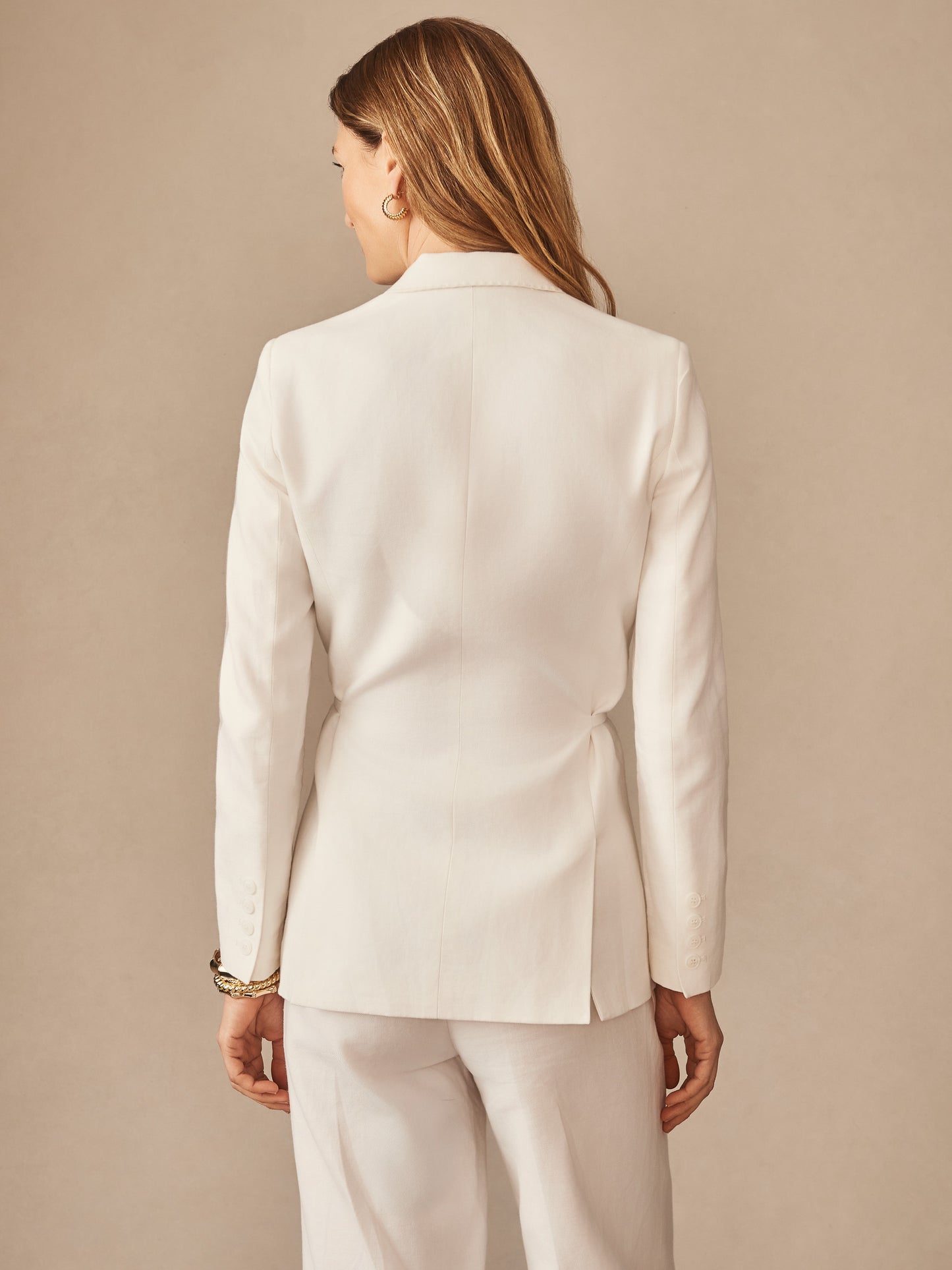 Woman wearing a white Biltmore Linen Blend Blazer by J.McLaughlin, showcasing impeccable craftsmanship and innovative fabrics for effortlessly stylish, enduring designs.