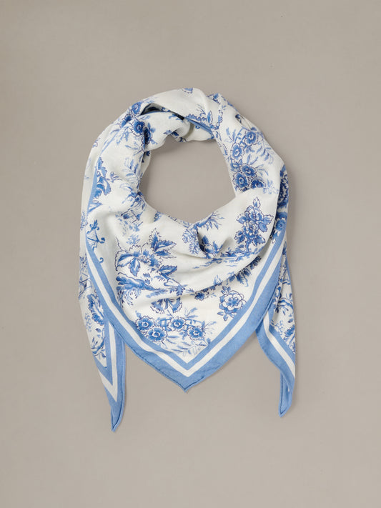 The Blair Scarf in Antique Toile Corner by J.McLaughlin featuring a blue and white floral pattern in a lightweight triangular design for elegant styling
