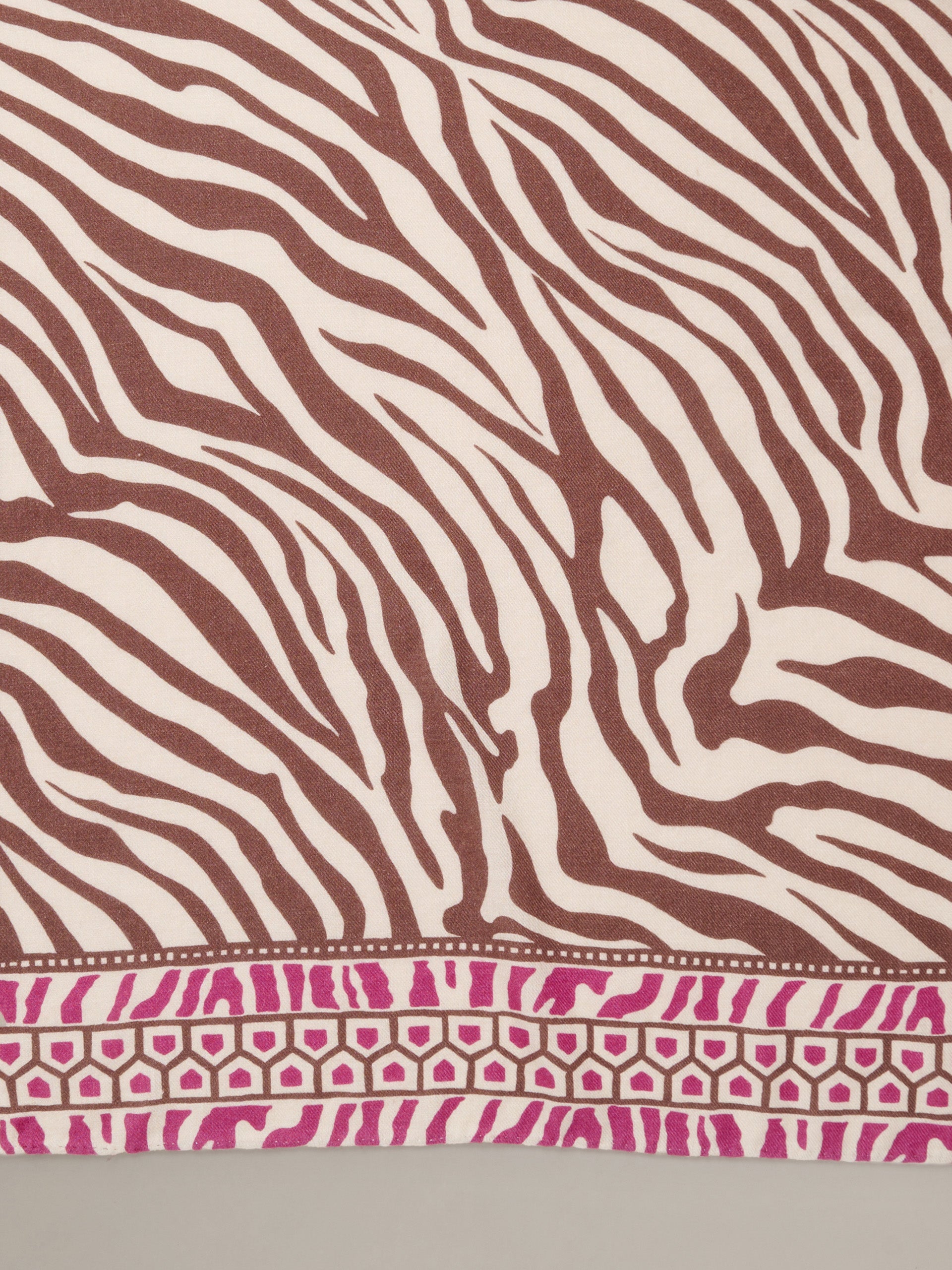 The Blair Scarf in Wild Medley Corner by J.McLaughlin featuring brown and cream zebra stripes with a pink geometric border on soft lightweight fabric