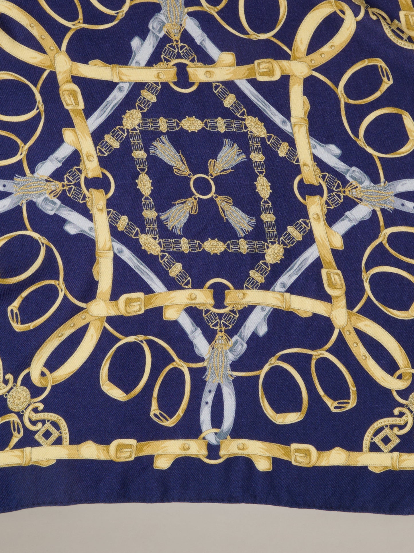 The Blair Scarf in Grand Heraldic Corner by J.McLaughlin featuring a navy cashmere silk scarf with an ornate gold equestrian heraldic pattern