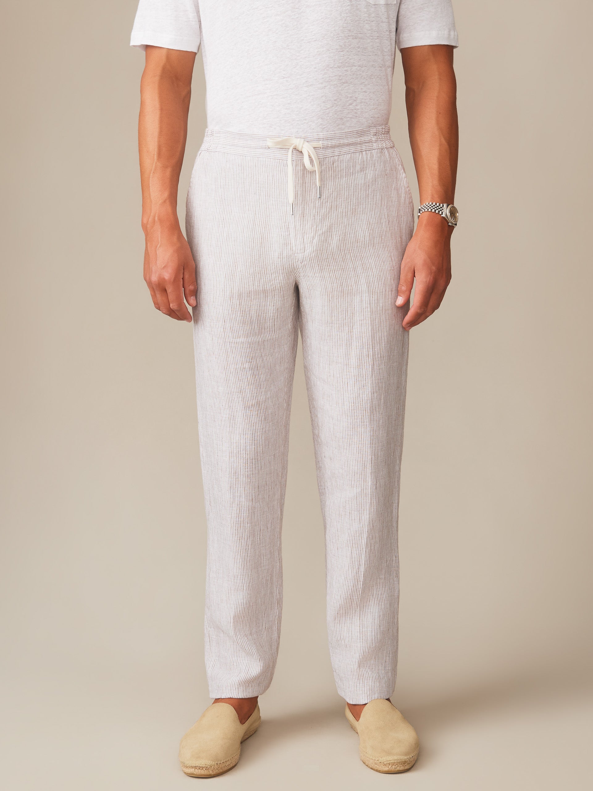 Man wearing Bleeker Linen Fancy Pants in Hairline Stripe by J.McLaughlin, featuring effortlessly stylish, enduring designs in lightweight linen for a destination for defining style. Life, Well-Lived.