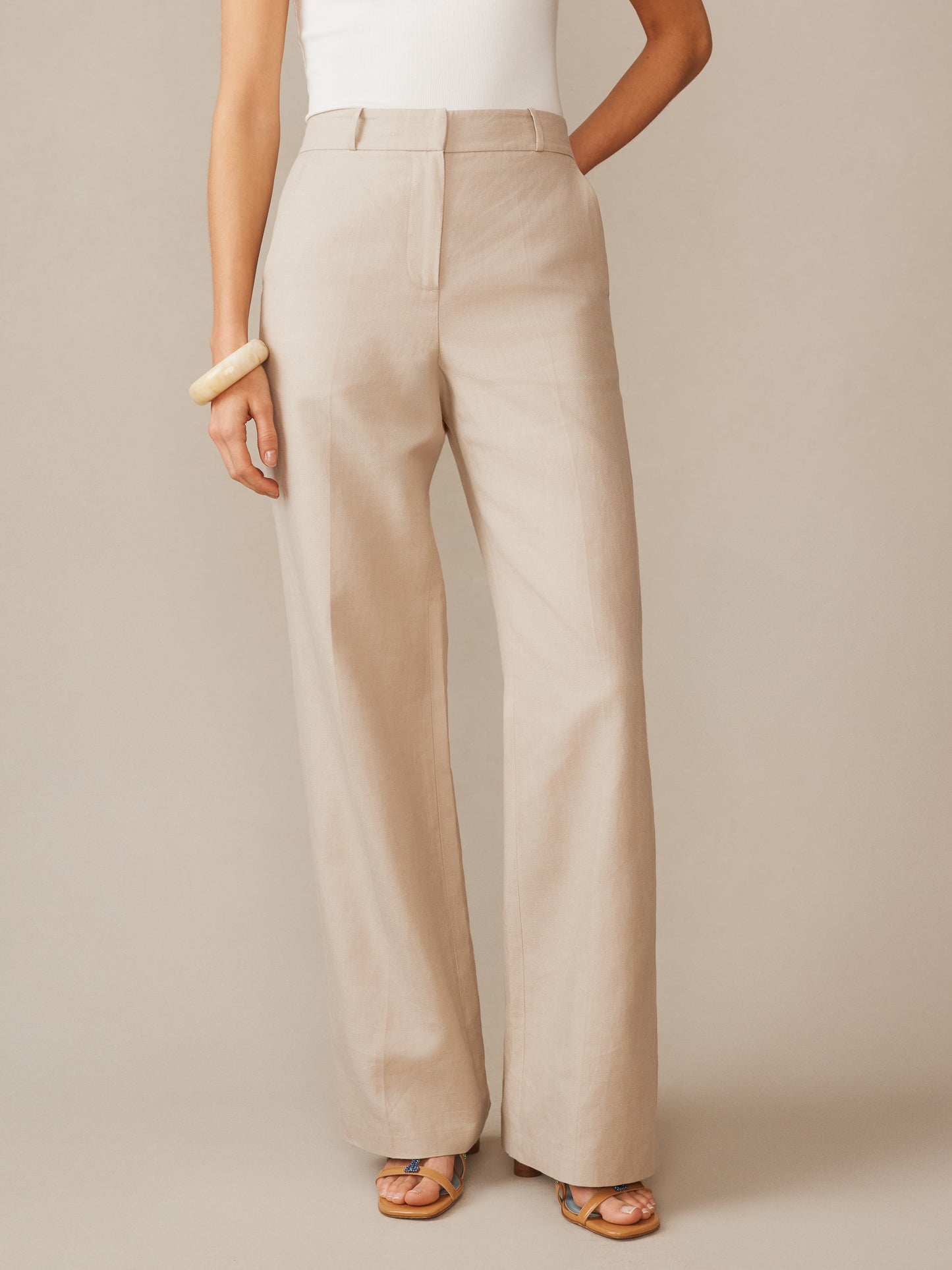 A model wearing Blythe Linen Blend Pants in a soft sand tone from J.McLaughlin, showcasing effortlessly stylish, enduring designs crafted from innovative fabrics.