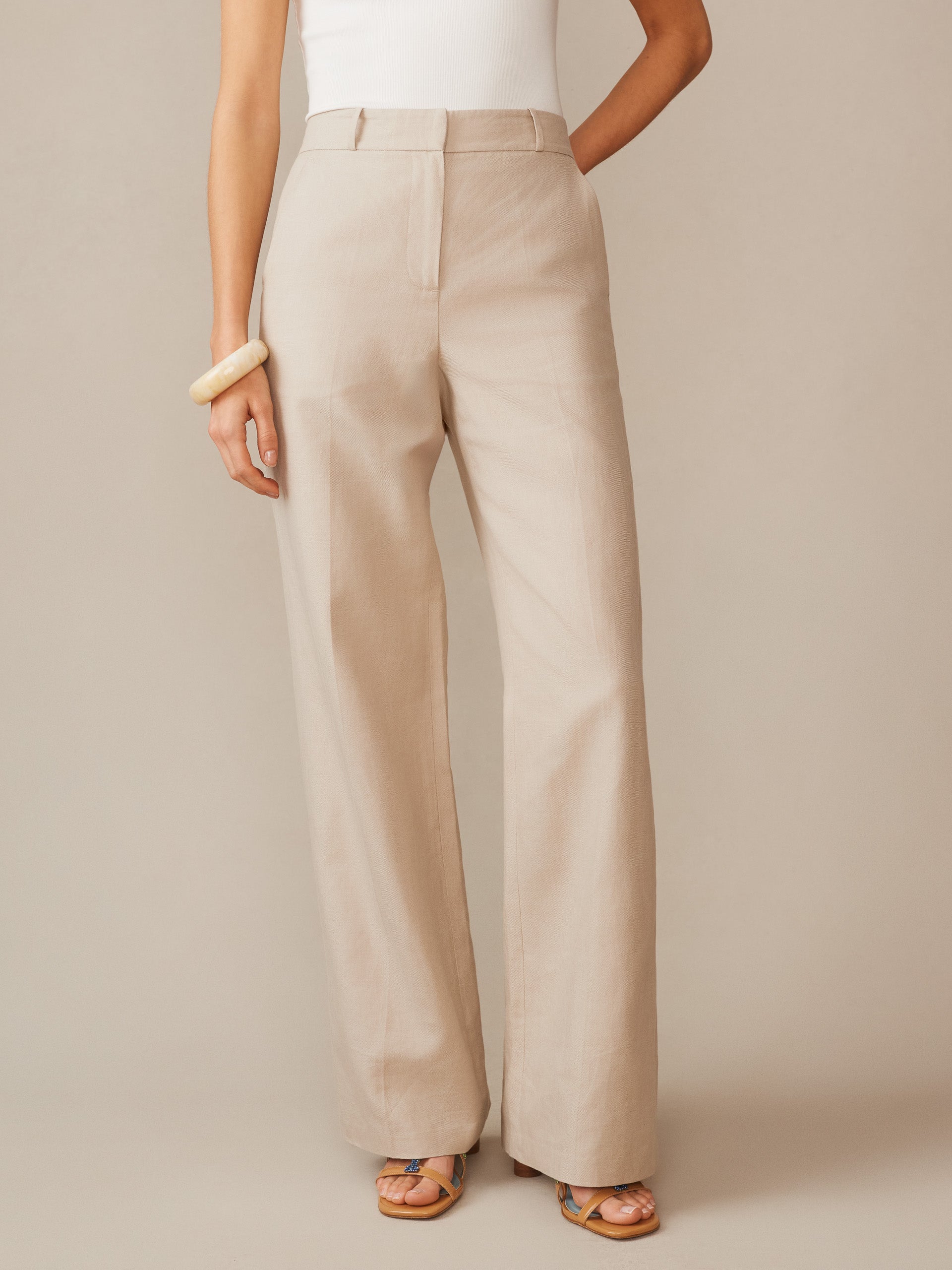 A model wearing Blythe Linen Blend Pants in a soft sand tone from J.McLaughlin, showcasing effortlessly stylish, enduring designs crafted from innovative fabrics.