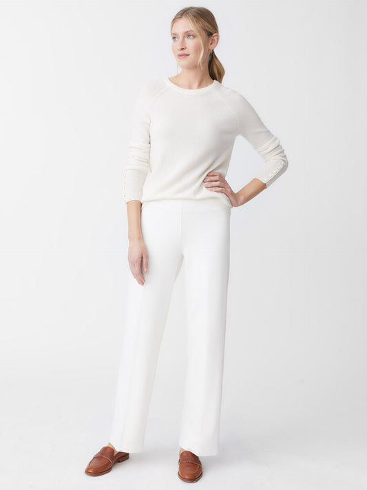 Model wearing J.McLaughlin Carter pants in ivory made with Bainbridge fabric.