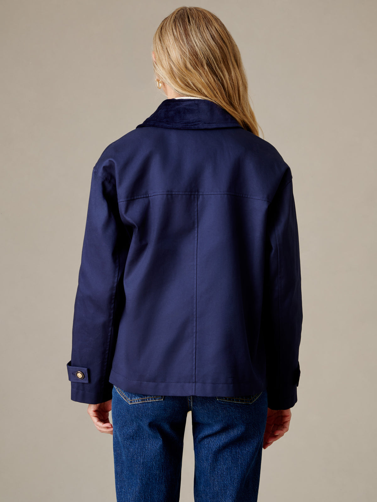 Brantley Jacket by J.McLaughlin shown from the back in navy with a clean tailored fit long sleeves and subtle detailing styled with blue jeans