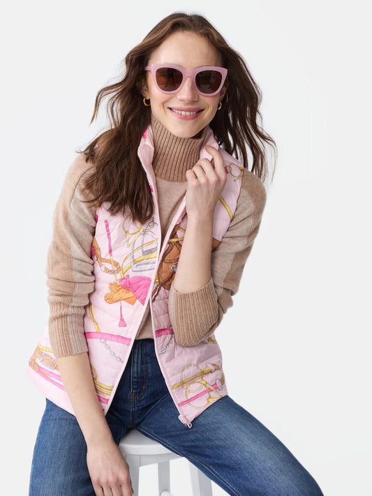 Model wearing J.McLaughlin Tahoe reversible vest in pink/light pink made with nylon.