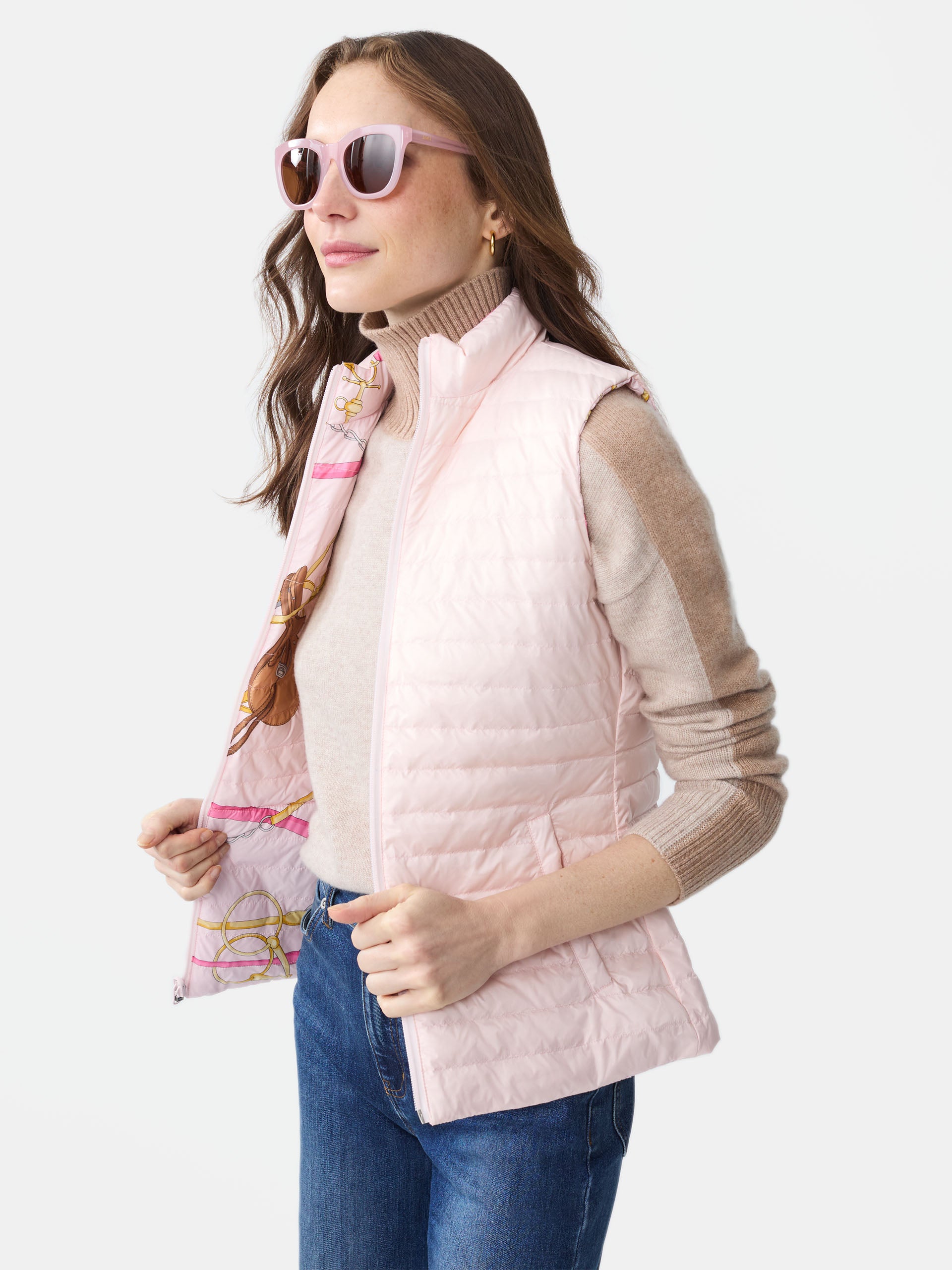 Model wearing J.McLaughlin Tahoe reversible vest in pink/light pink made with nylon.