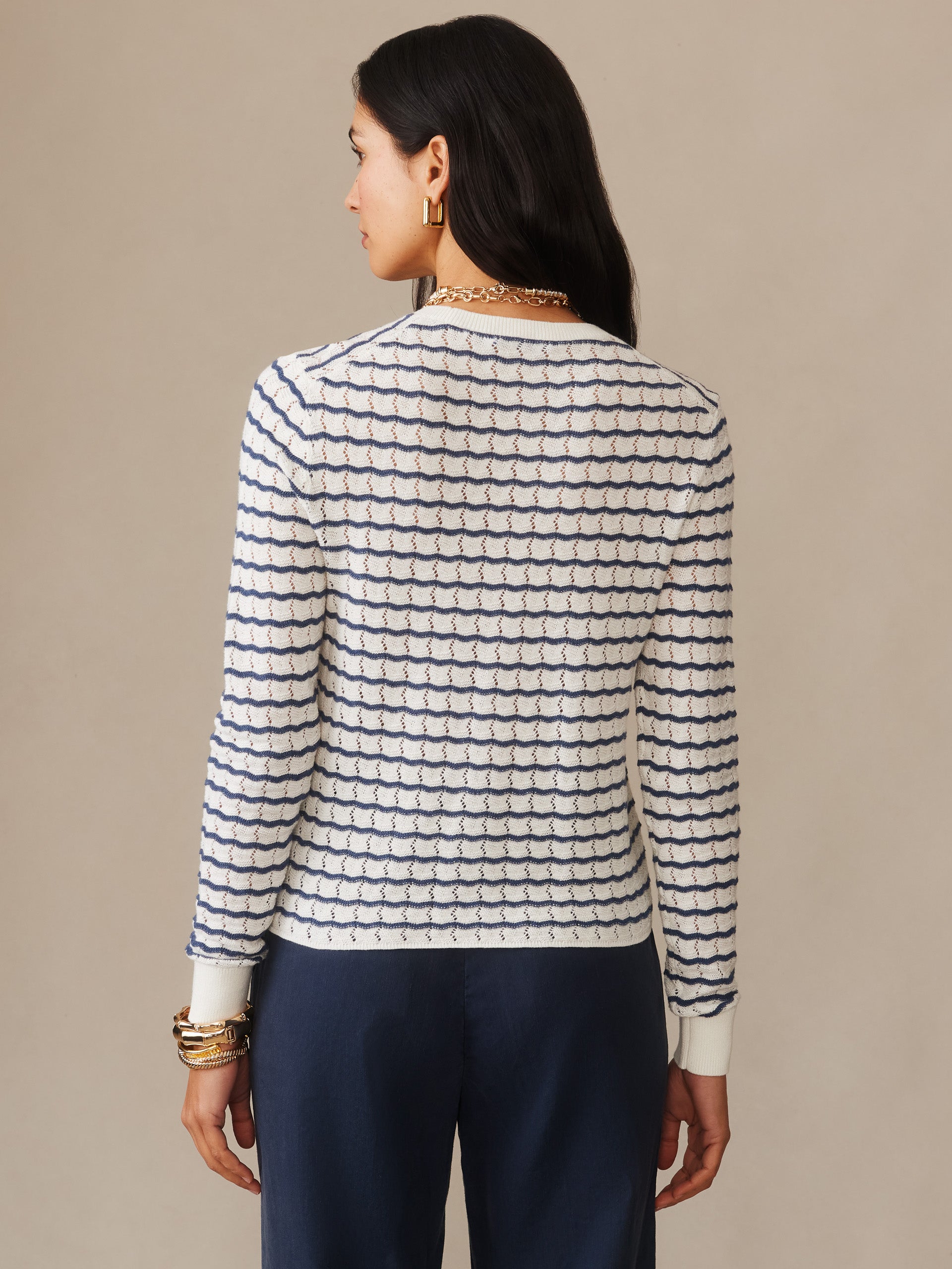 Woman seen from behind wearing the Brenna Sweater in Stripe by J.McLaughlin, featuring a classic striped design in off-white and denim blue, embodying effortlessly stylish, enduring designs with innovative fabrics. A destination for defining style. Life, Well-Lived.