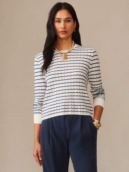 Woman wearing a Brenna Sweater in Stripe by J.McLaughlin, featuring off-white and navy textured stripes paired with navy pants, showcasing effortlessly stylish, enduring designs and innovative fabrics from a destination for defining style. Life, Well-Lived.