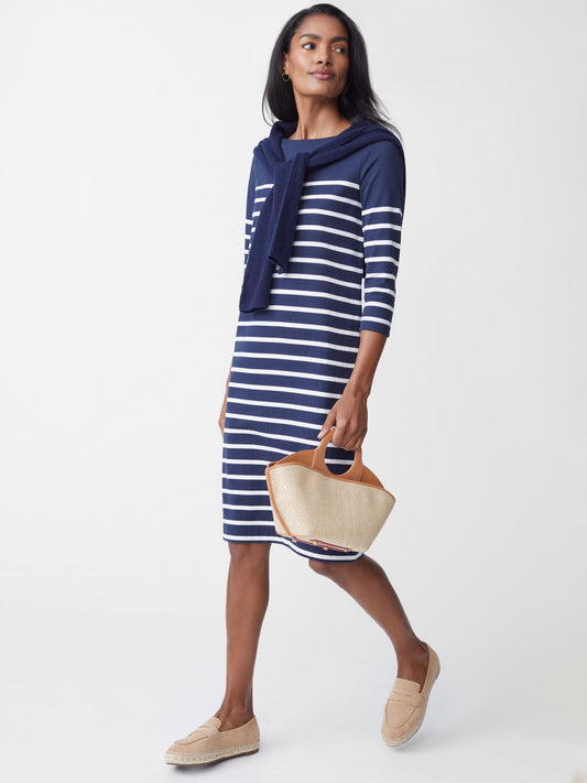Model wears J.McLaughlin Brinker Dress in Stripe in navy and white made with cotton.
