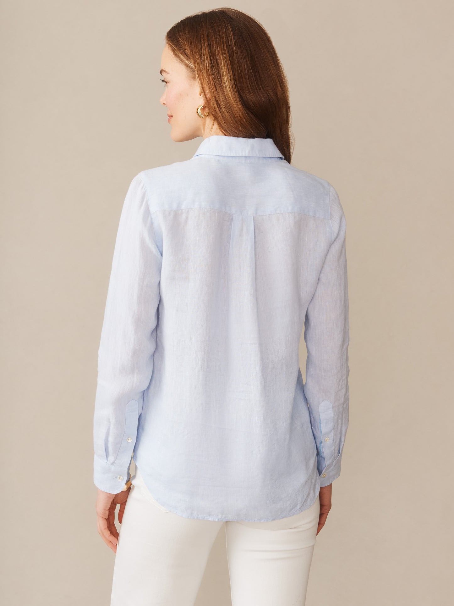 Model wearing J.McLaughlin Britt shirt in sky blue made with linen.