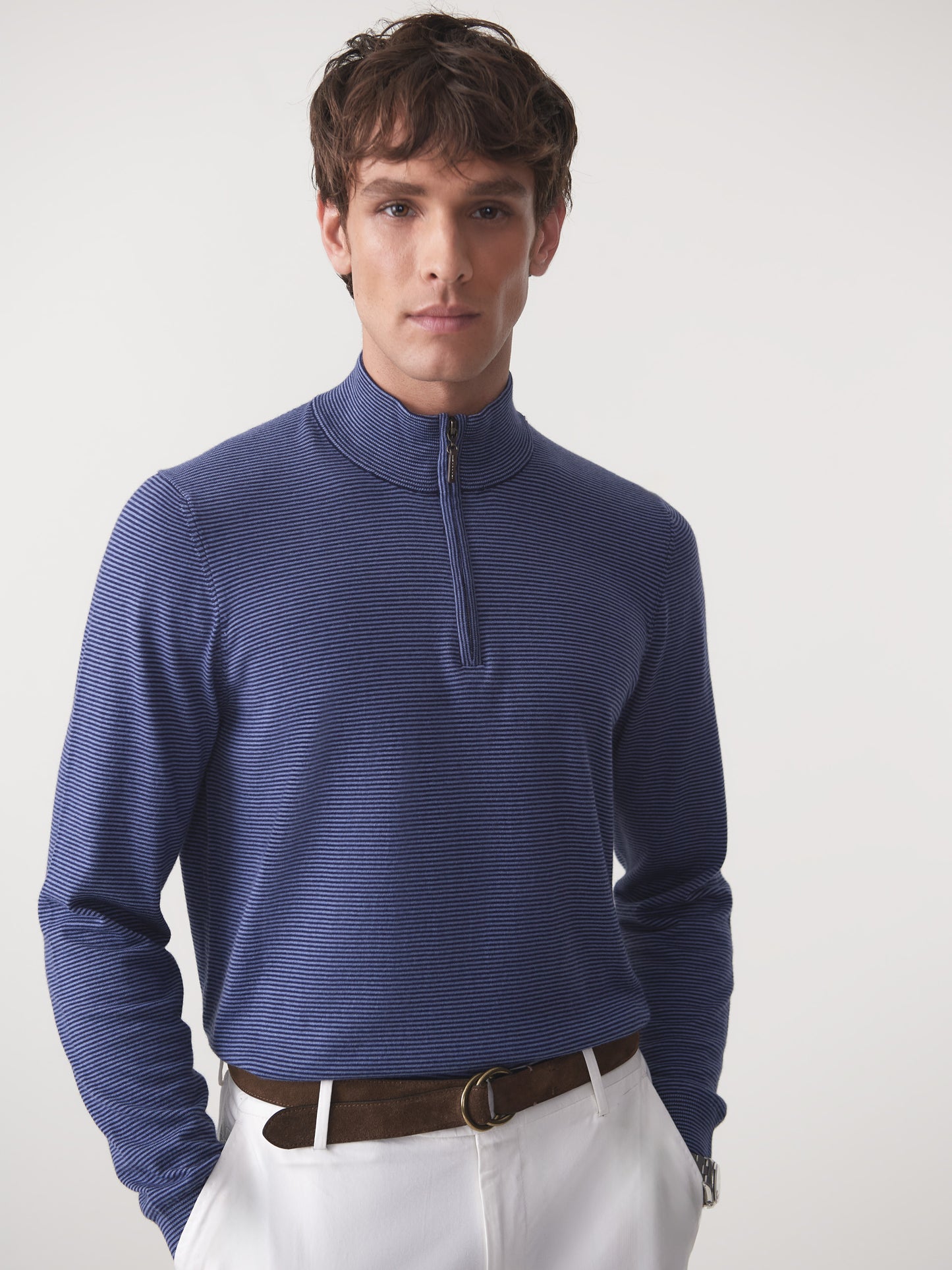 Model wearing J.McLaughlin Brookhaven sweater in navy/denim made with cotton, viscose, nylon, and cashmere.