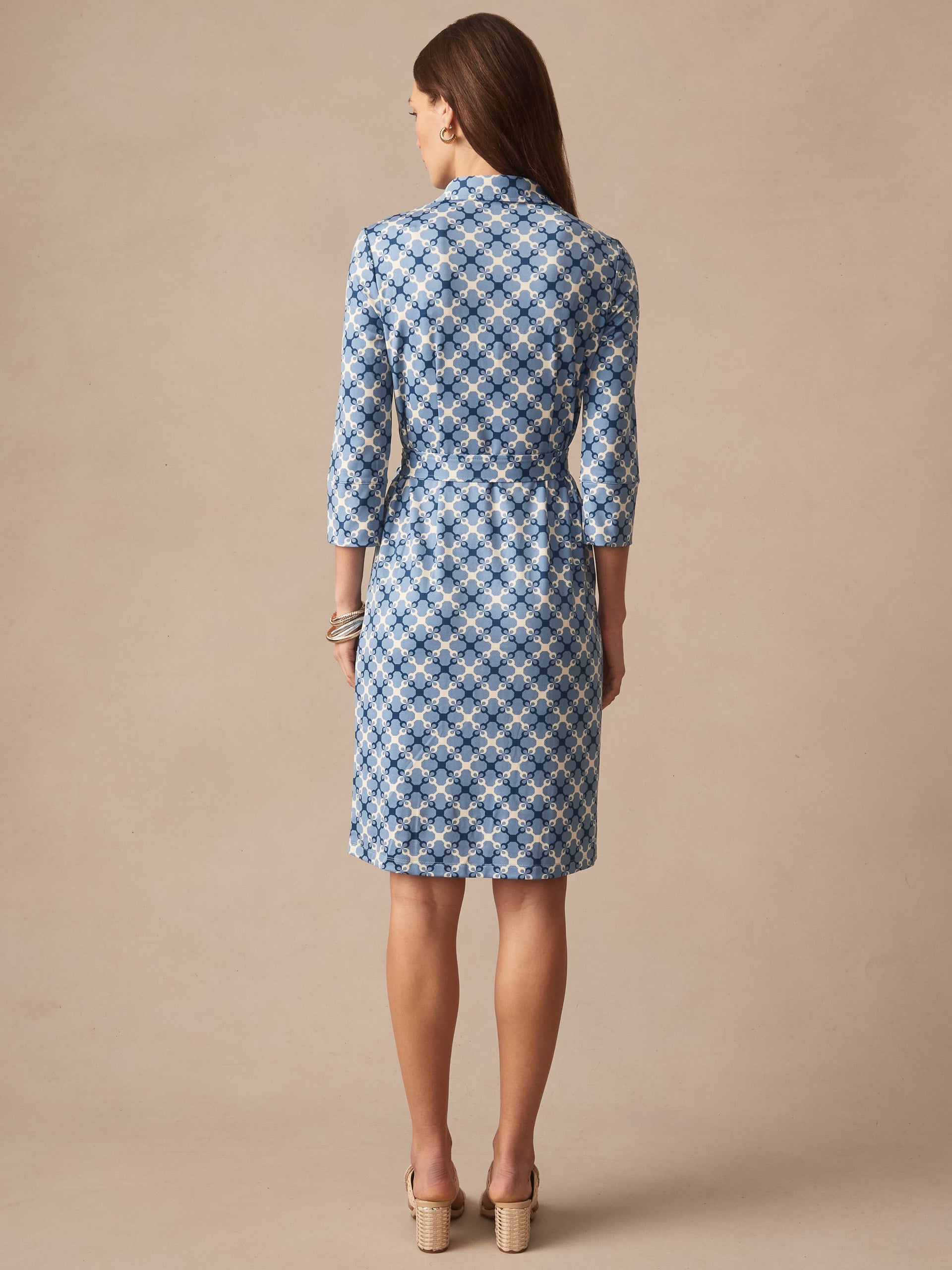 Woman wearing J.McLaughlin Brynn Dress in Essex Geo, showcasing effortlessly stylish, enduring designs with innovative fabrics in a timeless blue patterned dress, a destination for defining style. Life, Well-Lived.