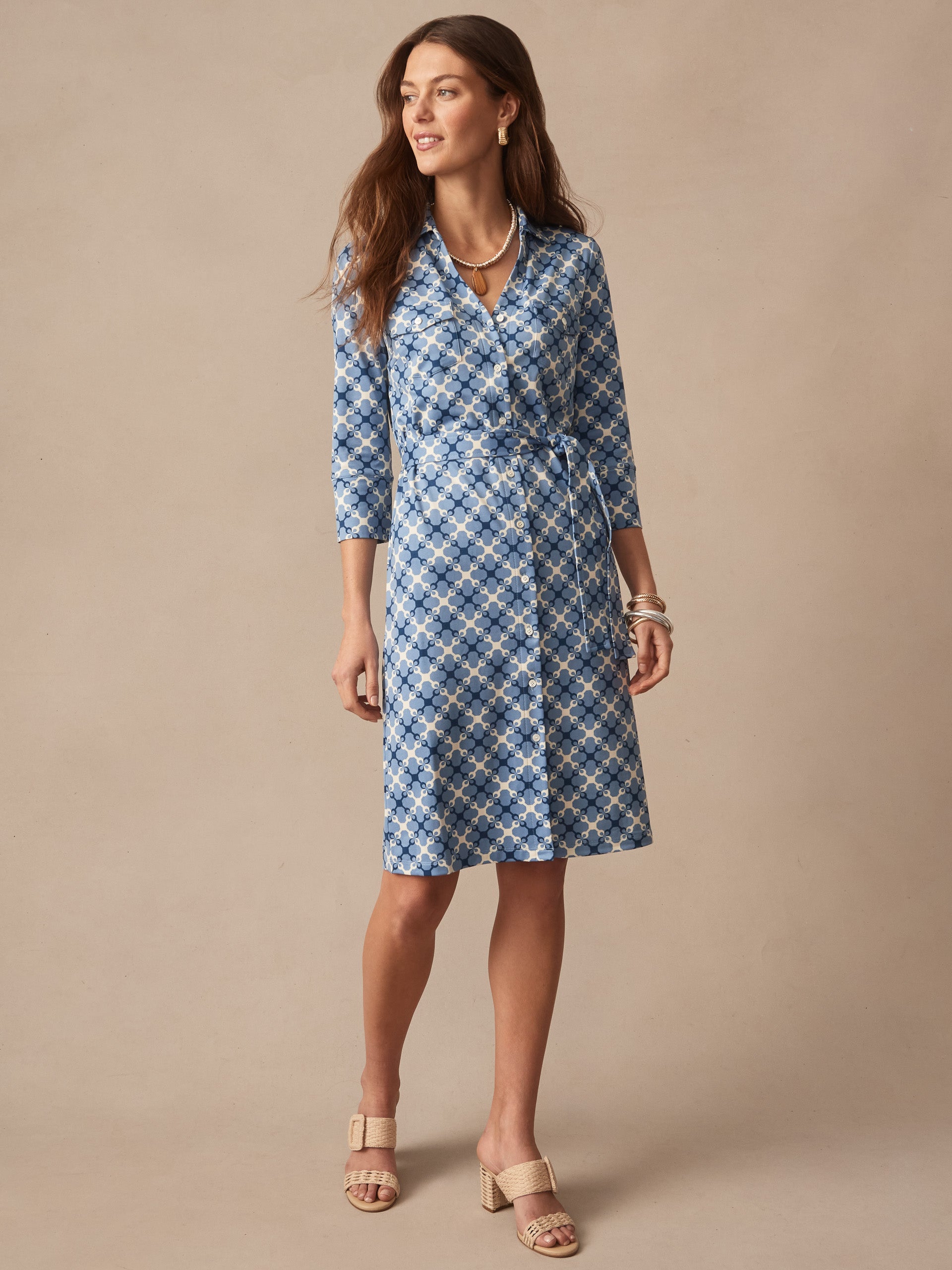 Woman wearing Brynn Dress in Essex Geo by J.McLaughlin, featuring an effortlessly stylish blue and navy geometric print, embodying enduring designs with innovative fabrics and timeless fashion.