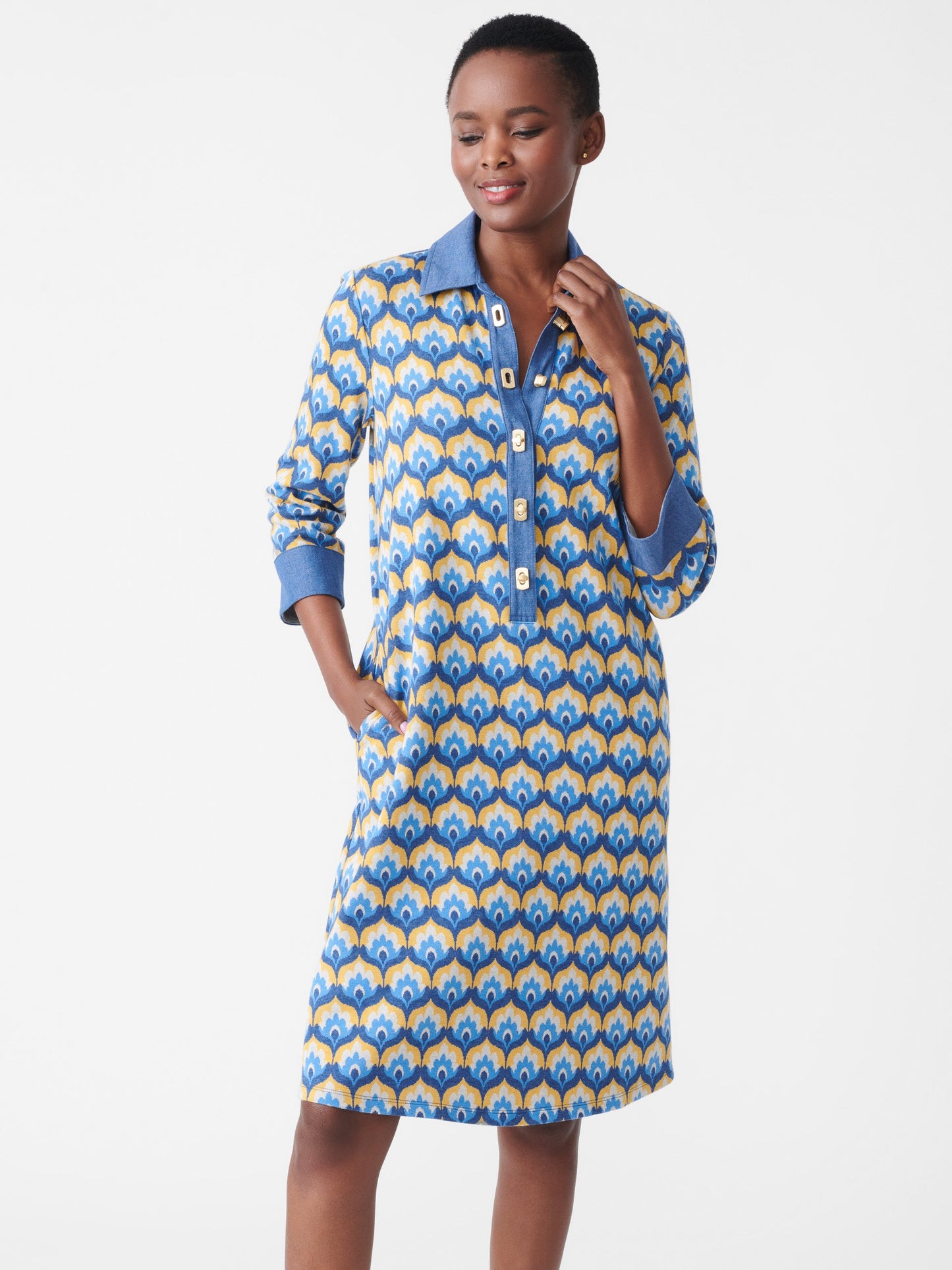 Model wearing J.McLaughlin Bryony dress in denim/gold made with cotton/polyester/elastane.