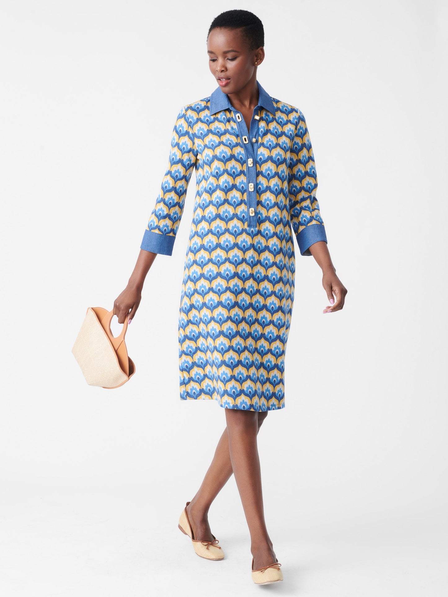 Model wearing J.McLaughlin Bryony dress in denim/gold made with cotton/polyester/elastane.