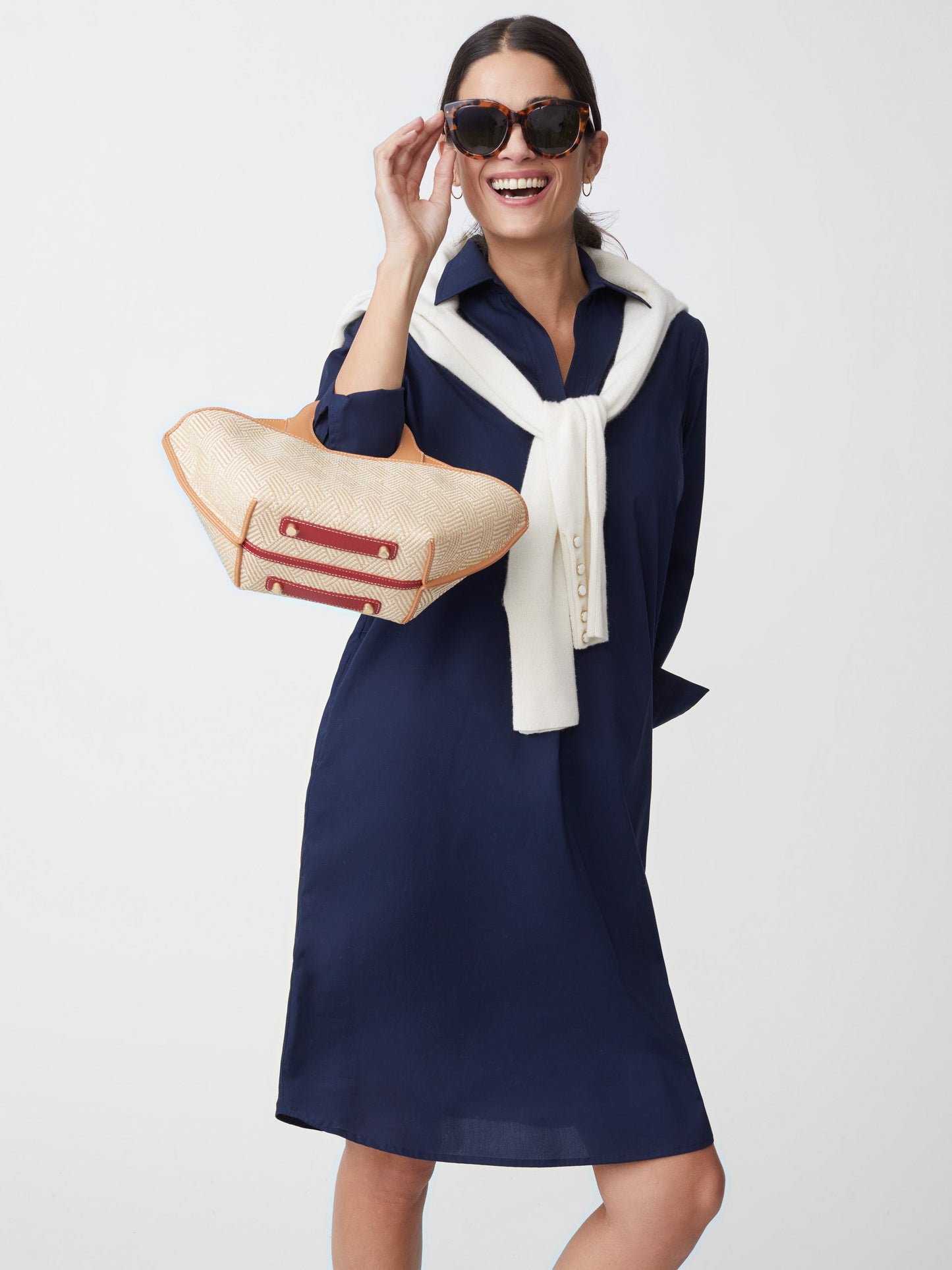 Model wears J.McLaughlin Cagney Dress in navy made with cotton and spandex.