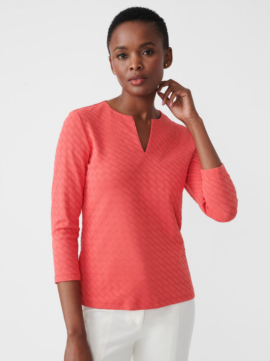 Model wearing J.McLaughlin Carly top in deep coral made with Catalina cloth jacquard.