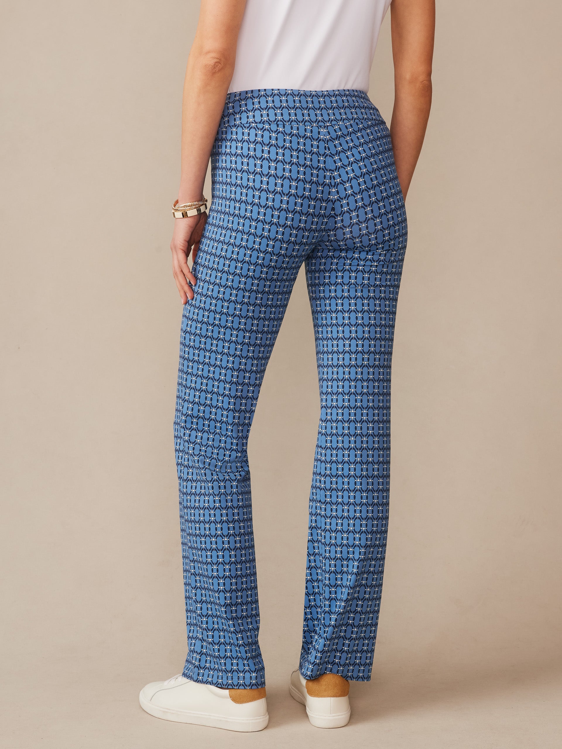 Back view of a person wearing J.McLaughlin Carmel Pants in Signet Lock, featuring a blue patterned design that reflects effortlessly stylish and enduring designs for a life well-lived.