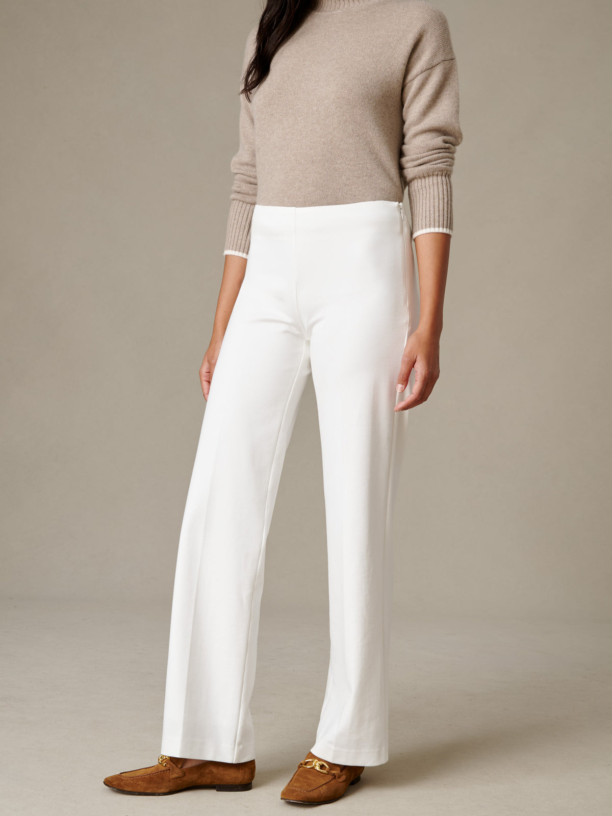 J.McLaughlin Carter Pants in white with a fluid wide leg silhouette styled with a neutral sweater and brown loafers