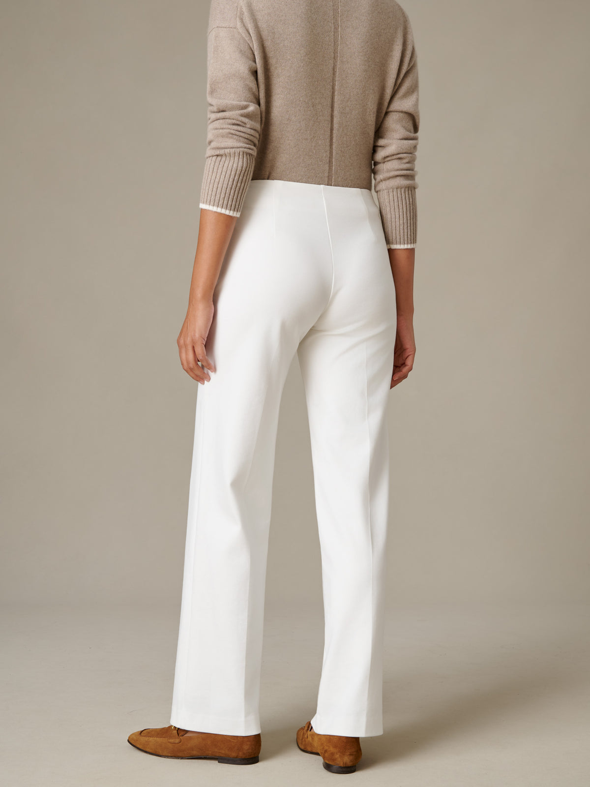 J.McLaughlin Carter Pants in white with a fluid wide leg silhouette styled with a soft taupe sweater and brown loafers