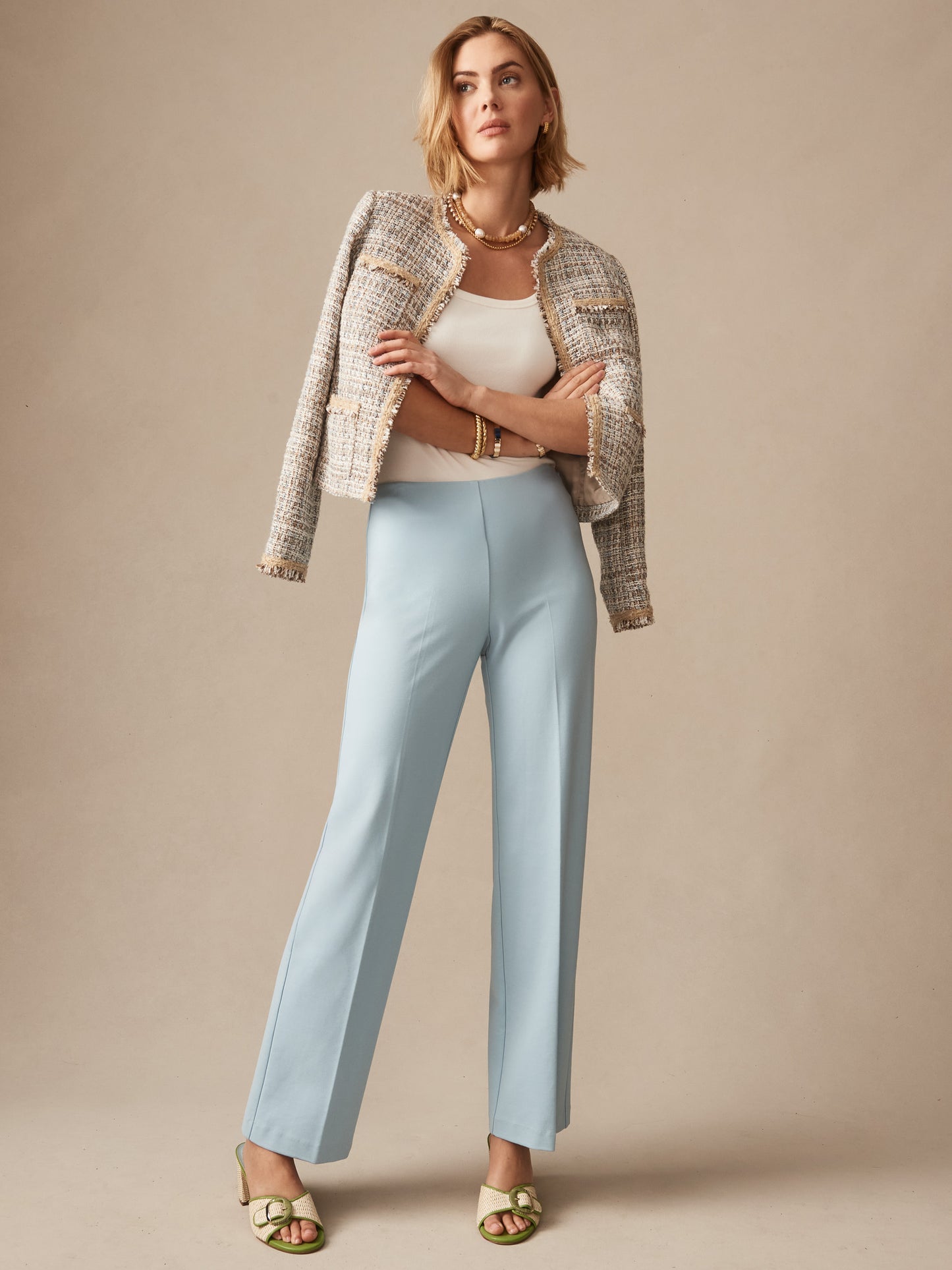 Woman wearing sky blue Carter Pants paired with a textured jacket and white top, showcasing J.McLaughlin's effortlessly stylish, enduring designs with innovative fabrics.