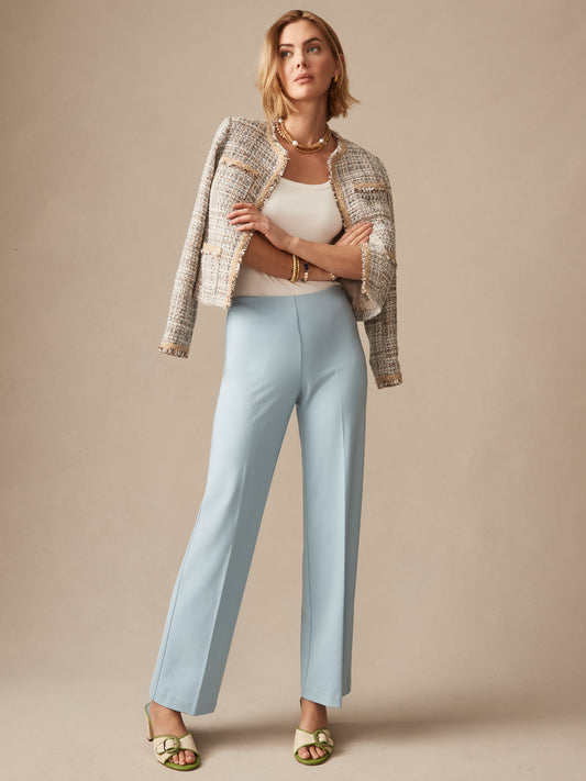 Woman wearing sky blue Carter Pants paired with a textured jacket and white top, showcasing J.McLaughlin's effortlessly stylish, enduring designs with innovative fabrics.