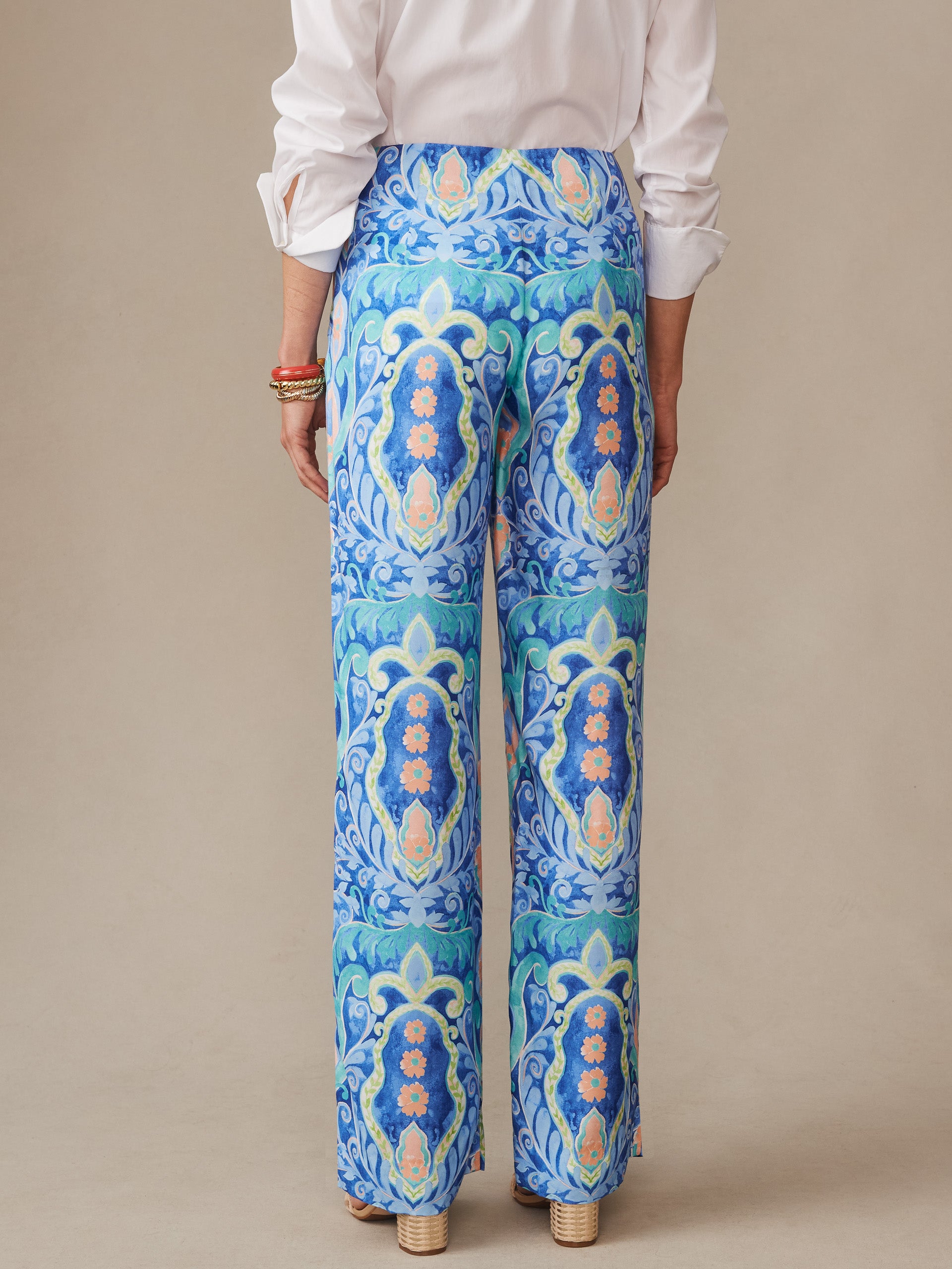 A model wearing J. McLaughlin Carter Silk Blend Pants in Mini Deco Bloom, showcasing effortlessly stylish pants with enduring designs and innovative fabrics, embodying a legacy of timeless fashion. A destination for defining style. Life, Well-Lived.