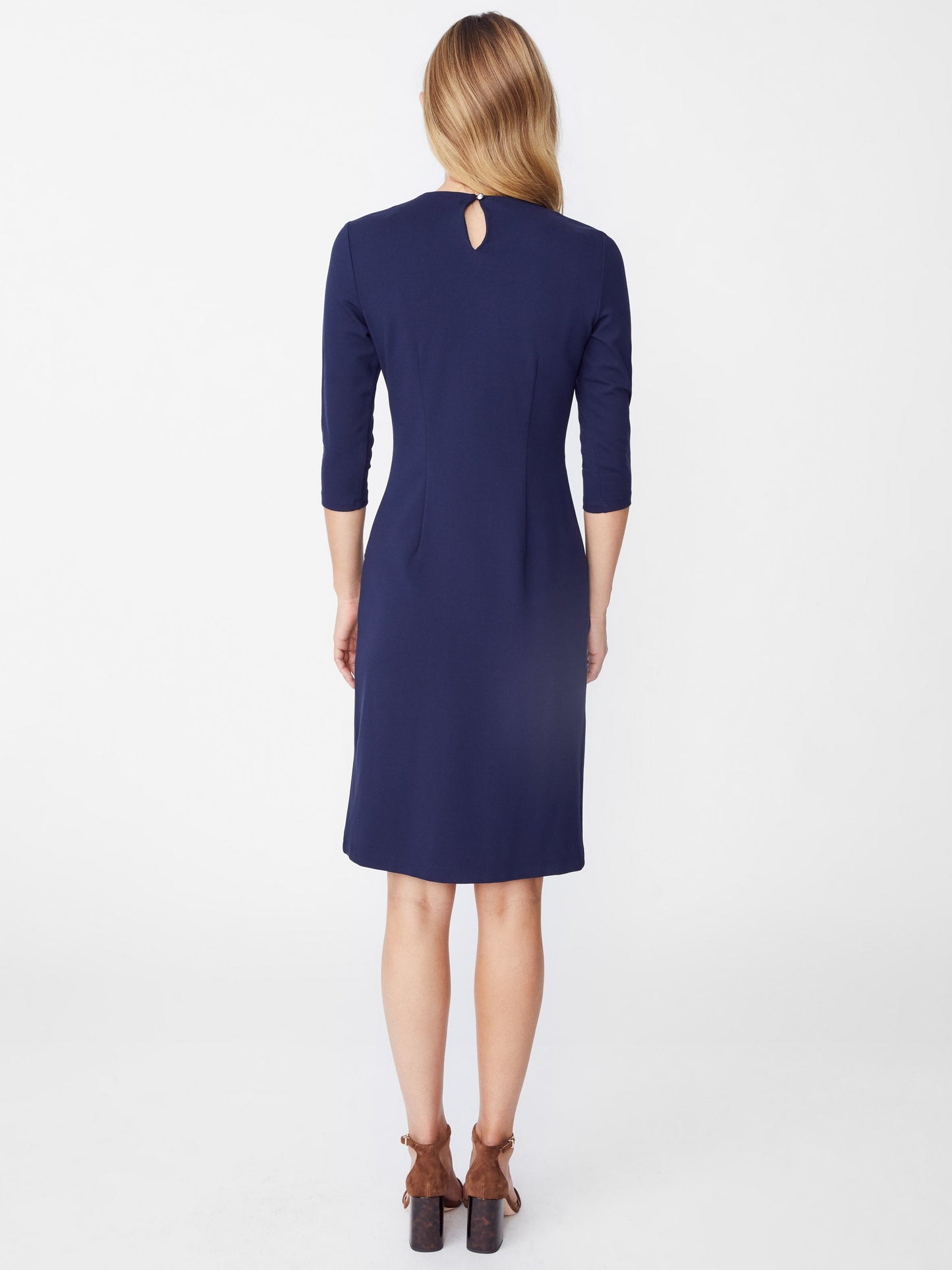 Model wearing J.McLaughlin Catalyst dress in winter navy made with bainbridge fabric.