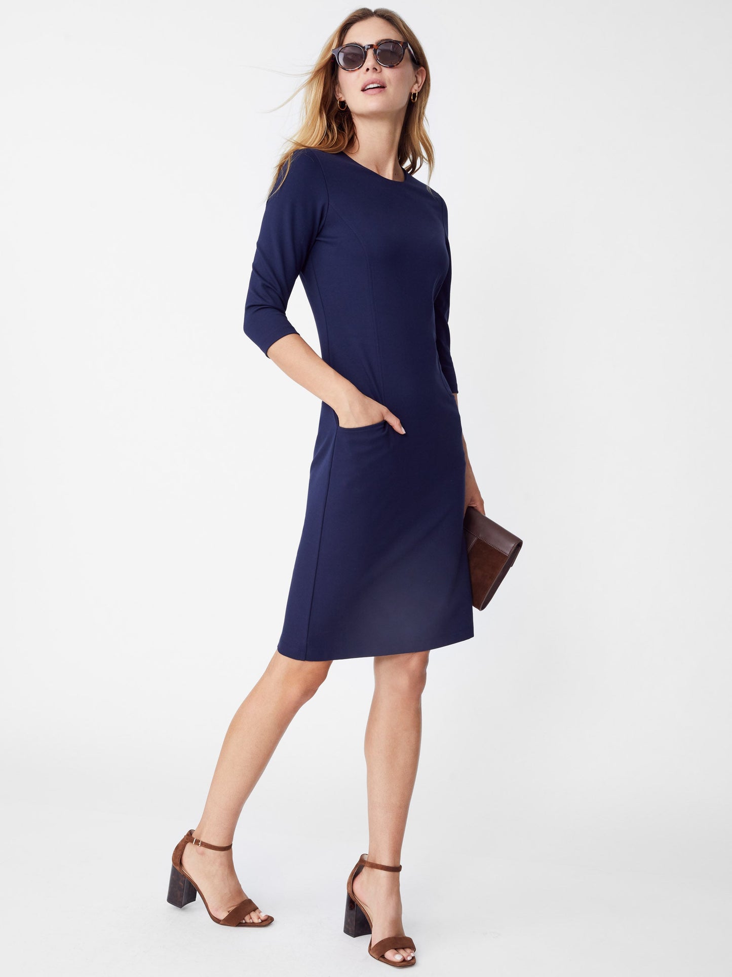 Model wearing J.McLaughlin Catalyst dress in winter navy made with bainbridge fabric.